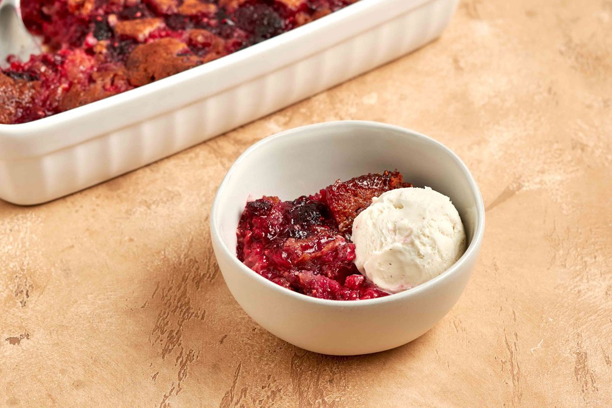 Raspberry Cobbler served in a bowl with ice cream