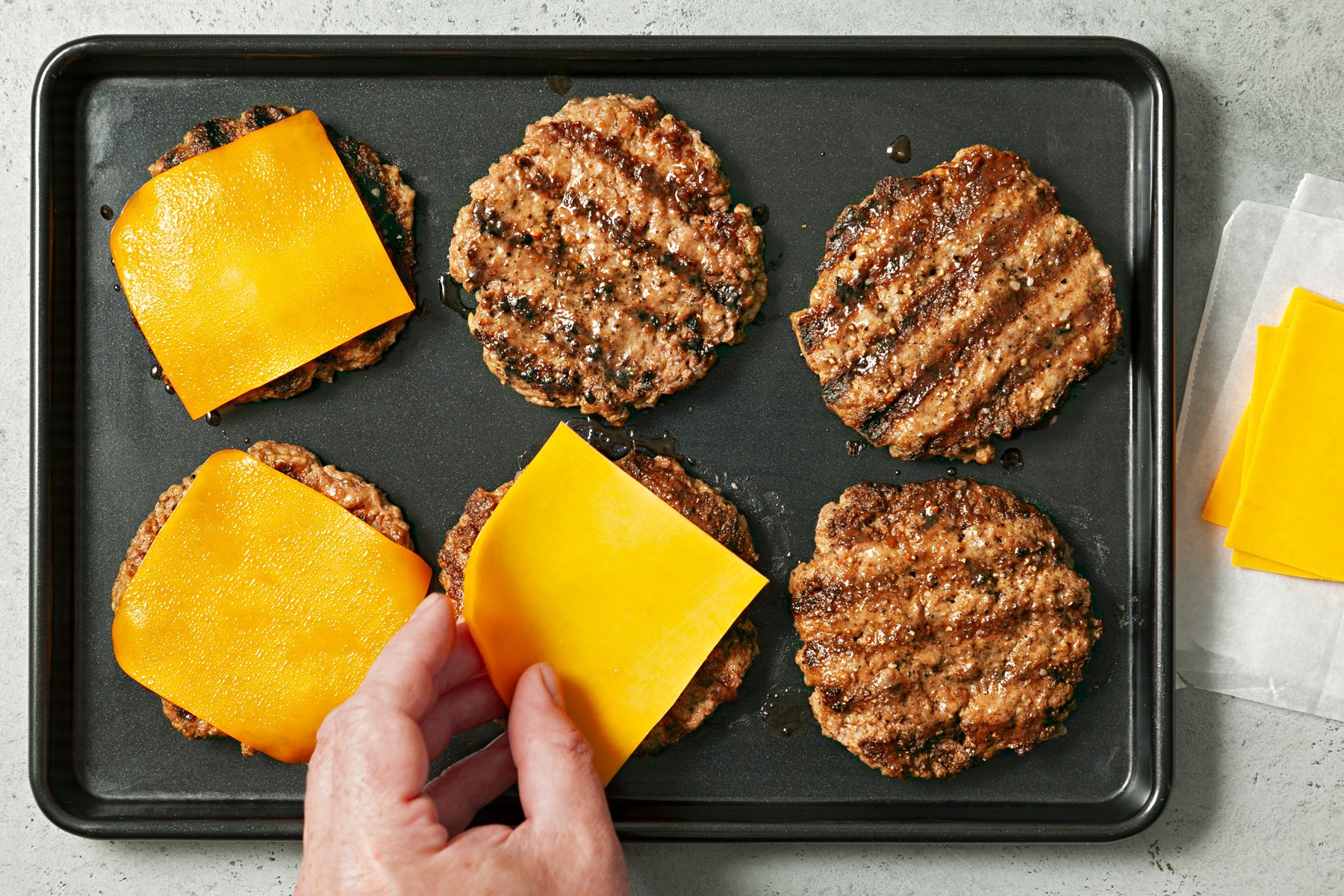 Add cheese slices on top of the grilled beef patties