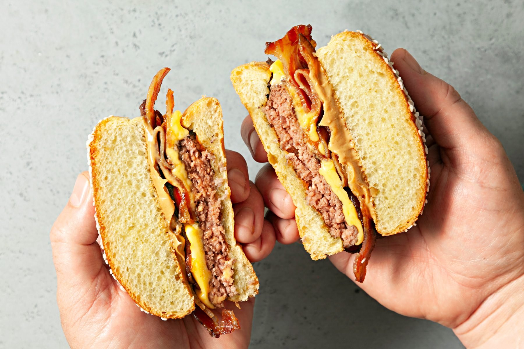 Peanut Butter Burger sliced into half to show the layers of ingredients