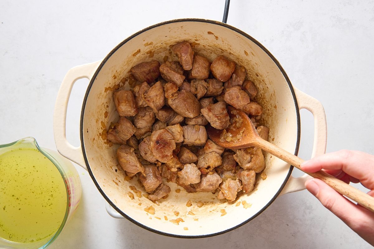 Browning the meat and onions in a dutch oven