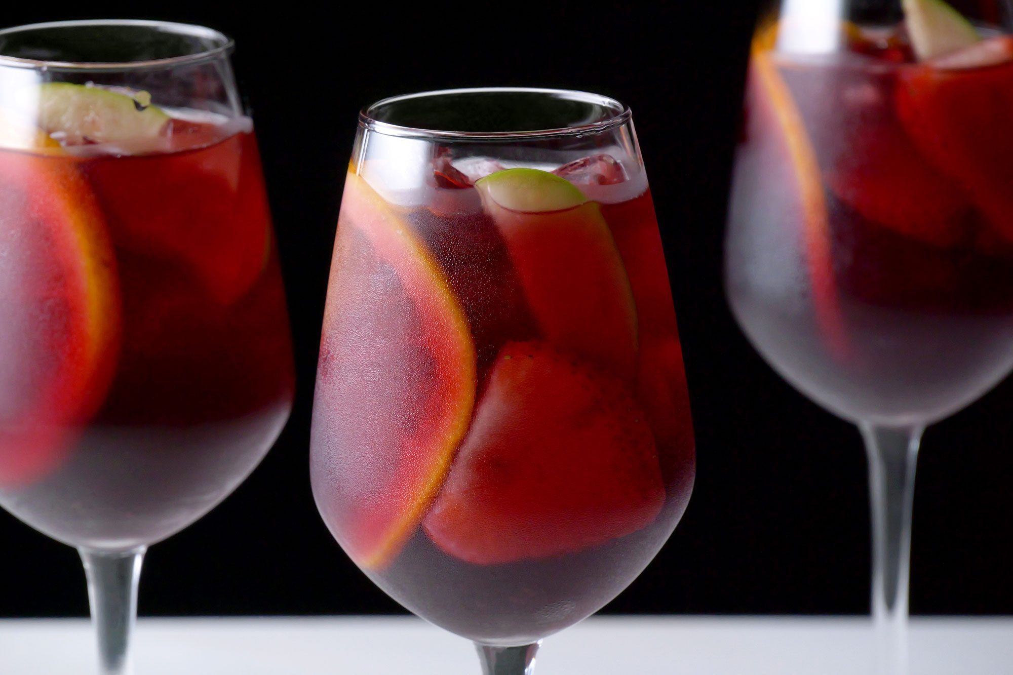 Red Sangria served in three glasses over ice