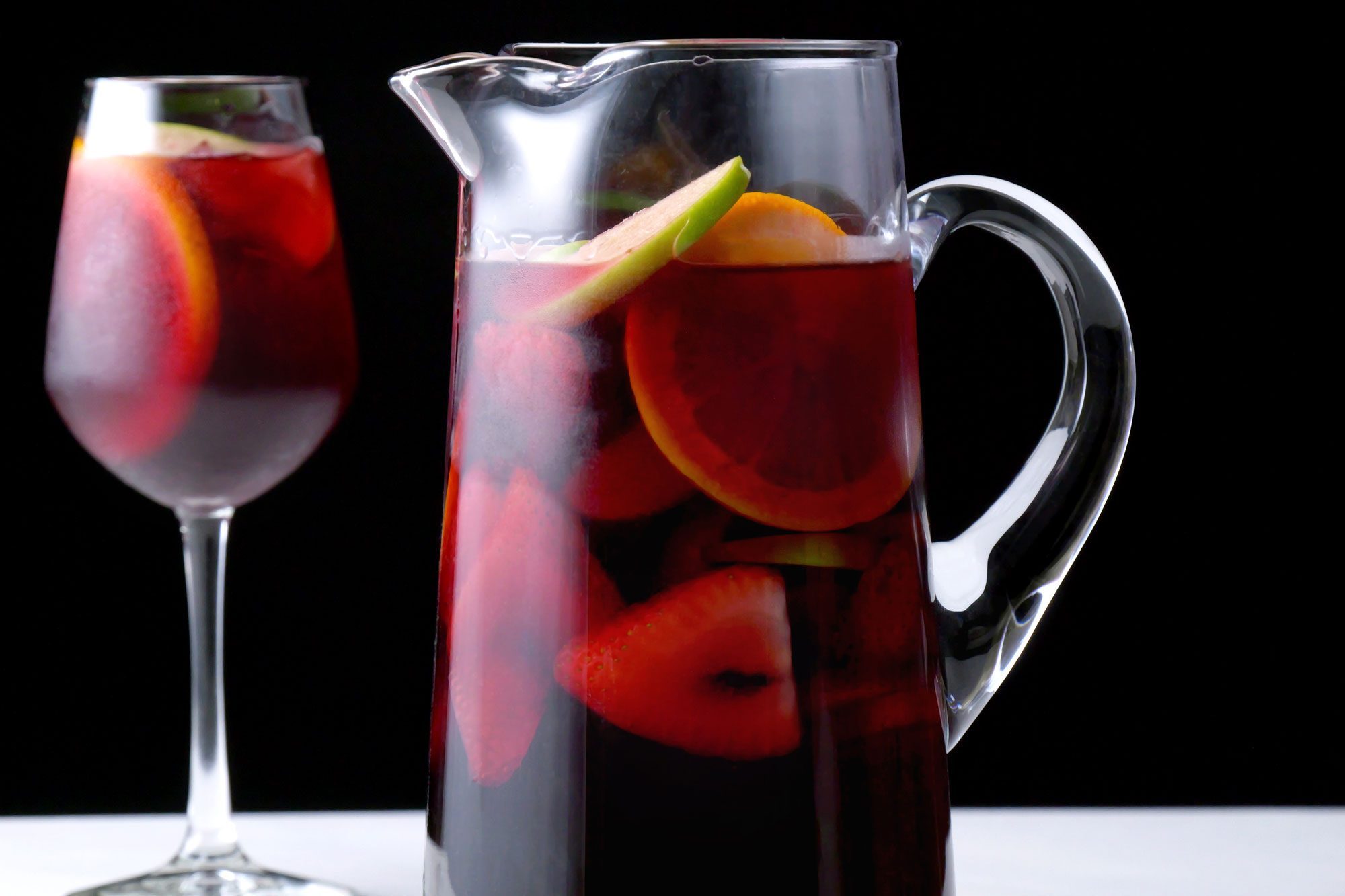 Red Sangria in pitcher served in glass over ice