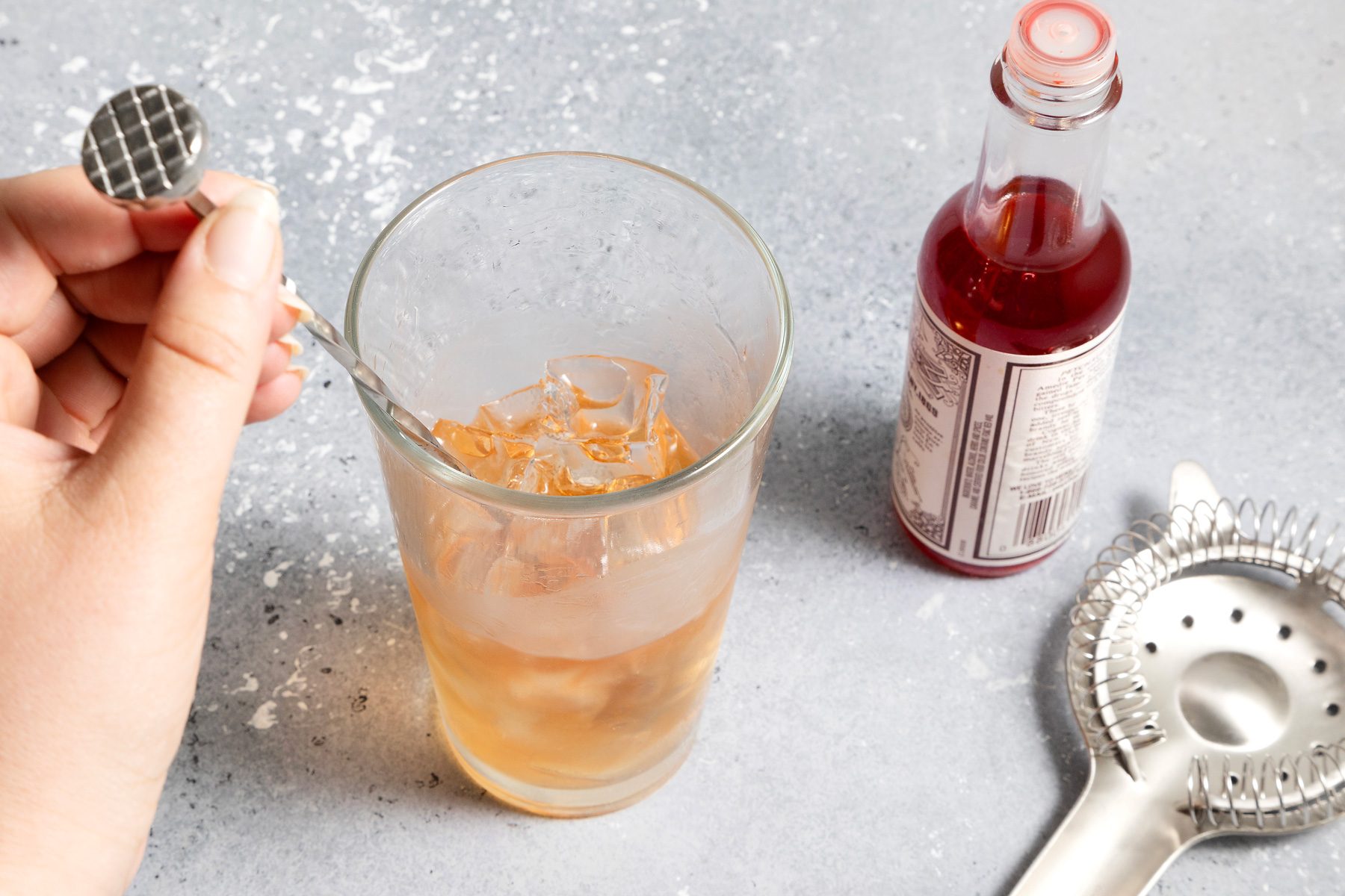 Mixing ingredients of Rusty Nail on a counter top