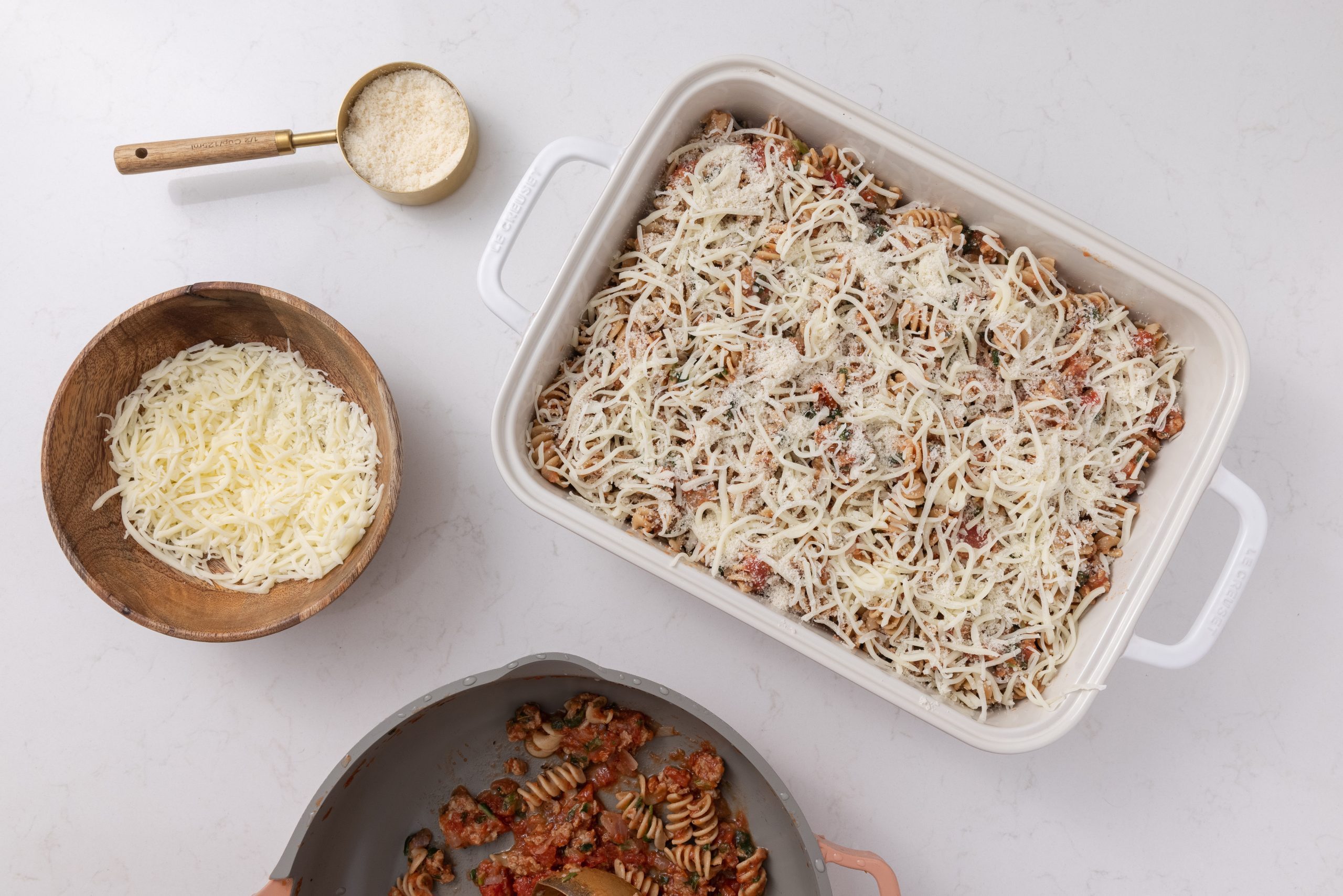 Sausage spinach pasta bake assembled in baking dish and ready to go in the oven. 