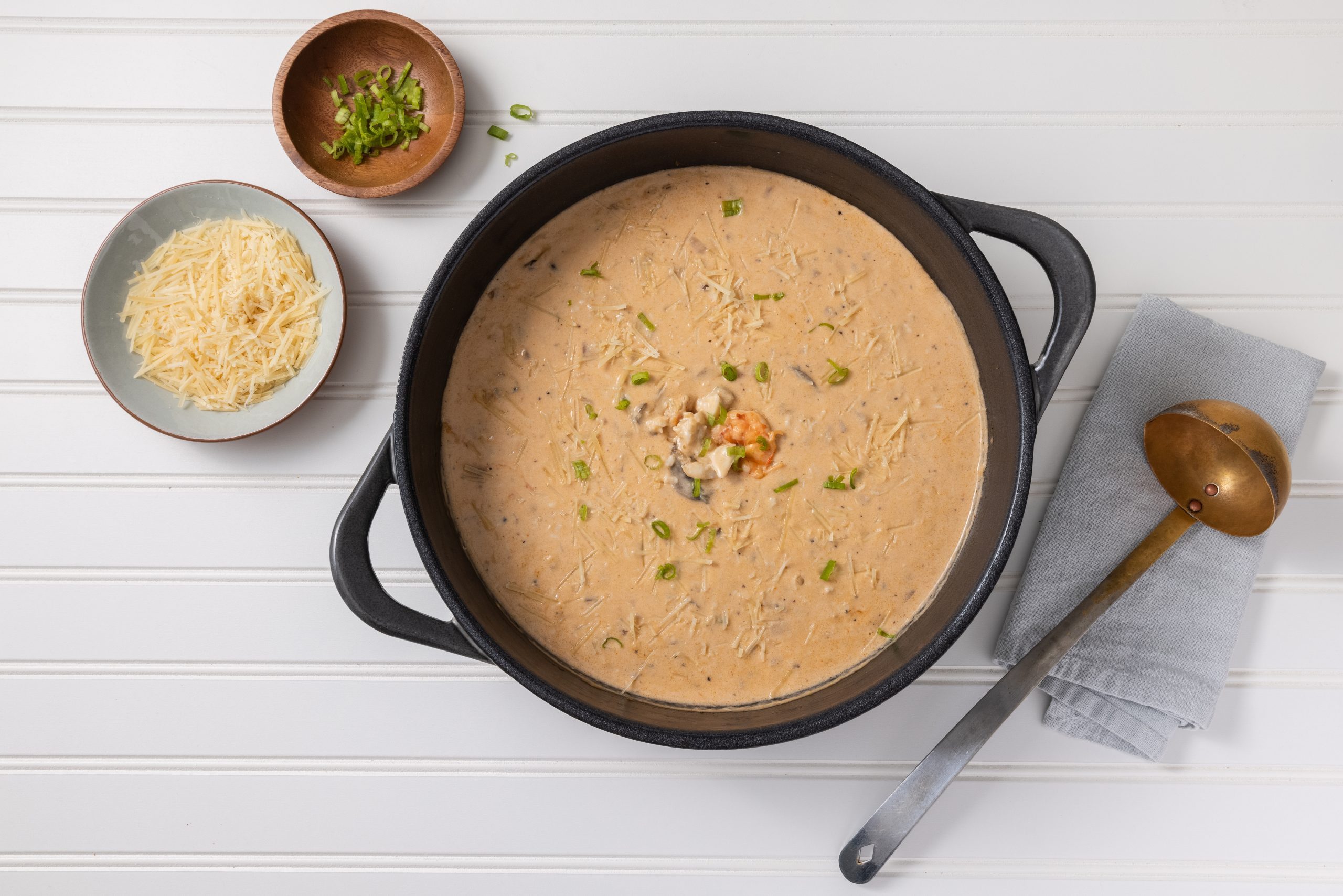 Seafood bisque on dutch oven after being finished and ready to serve.