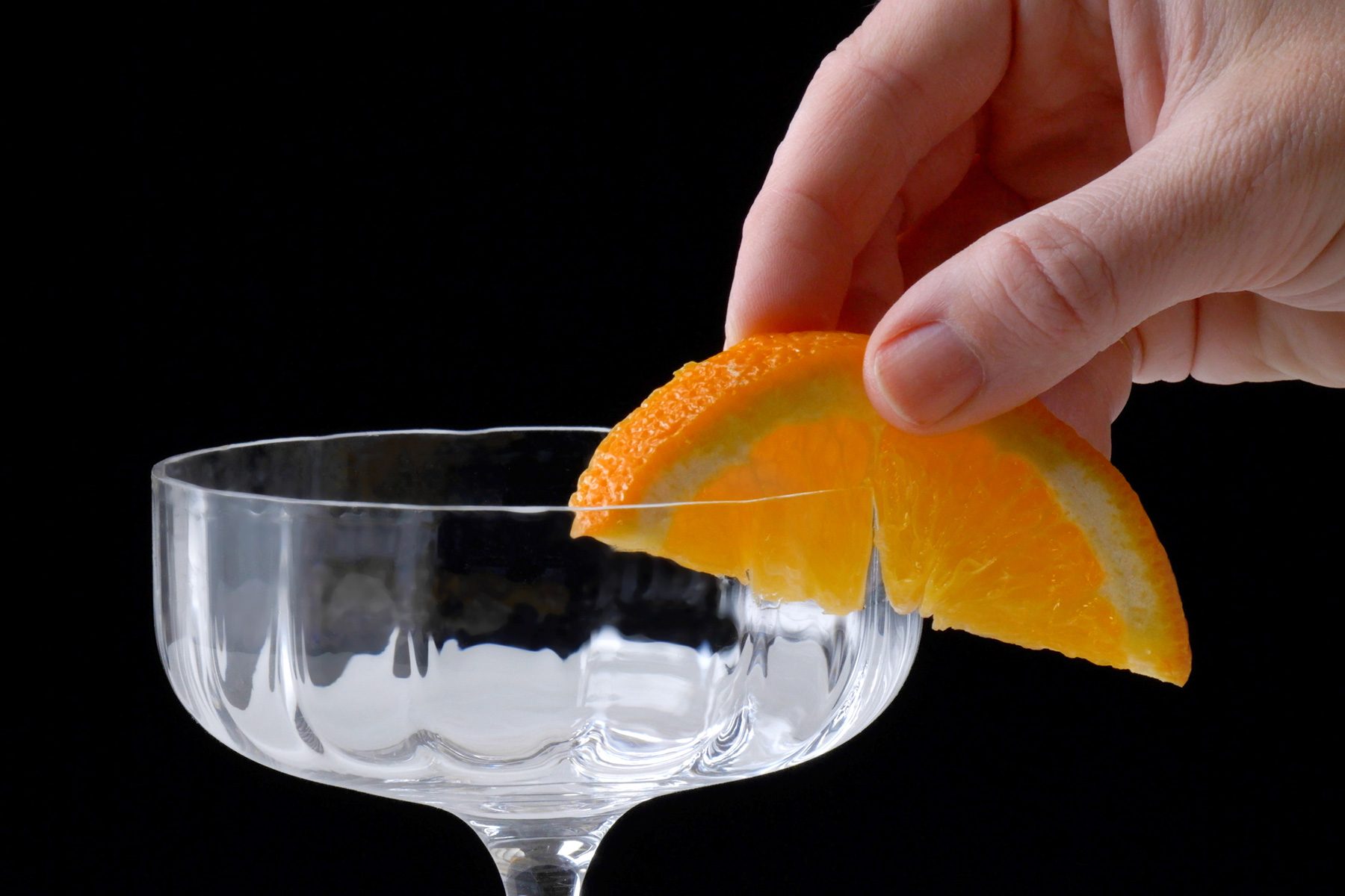 Orange slice rubbed on the edge of a Coupe glass