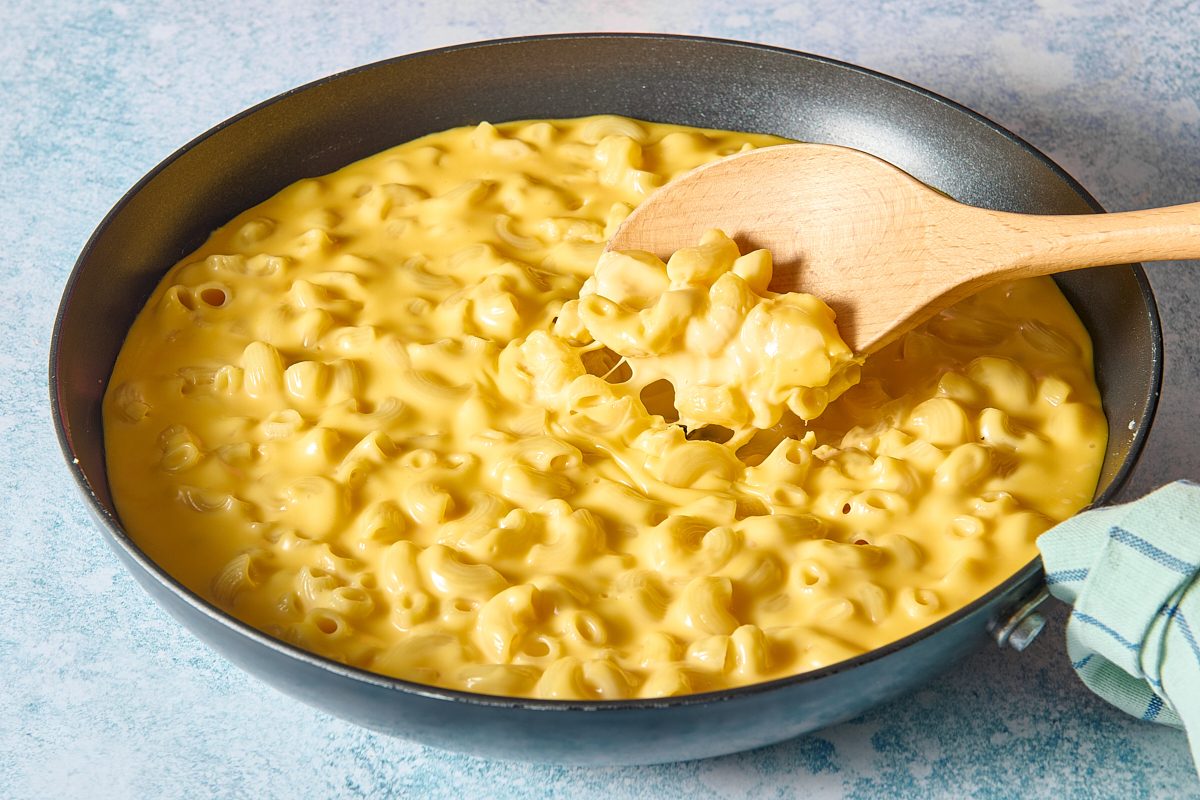 Closeup of skillet mac and cheese being scooped out with spoon