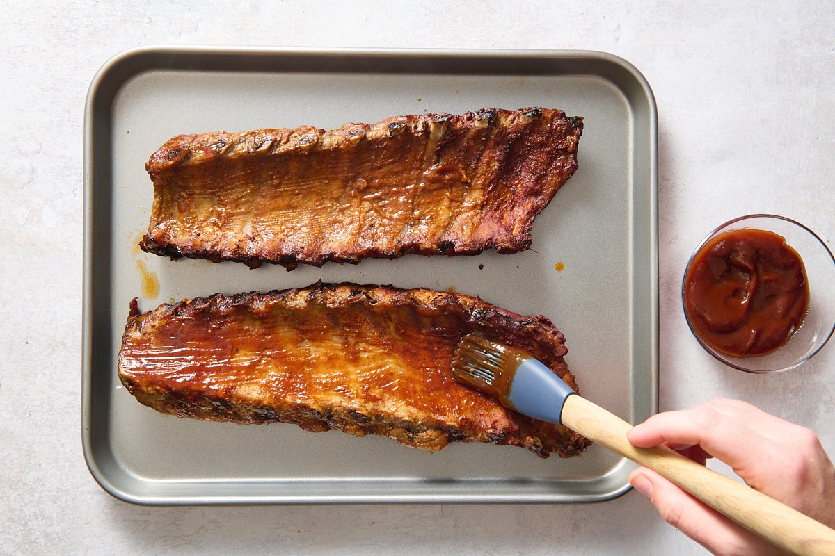 Basting ribs with barbecue sauce