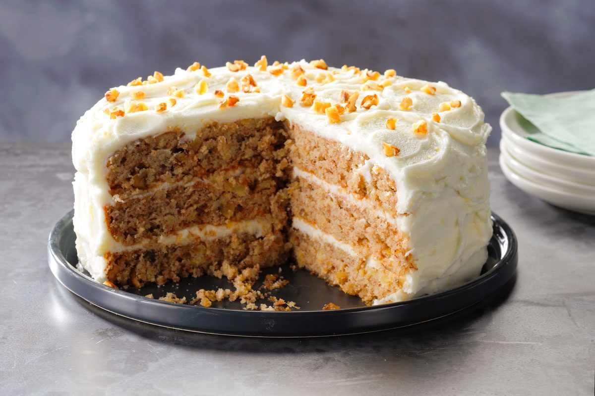 Hummingbird Cake with a large slice taken out showing the texture and layers inside the cake