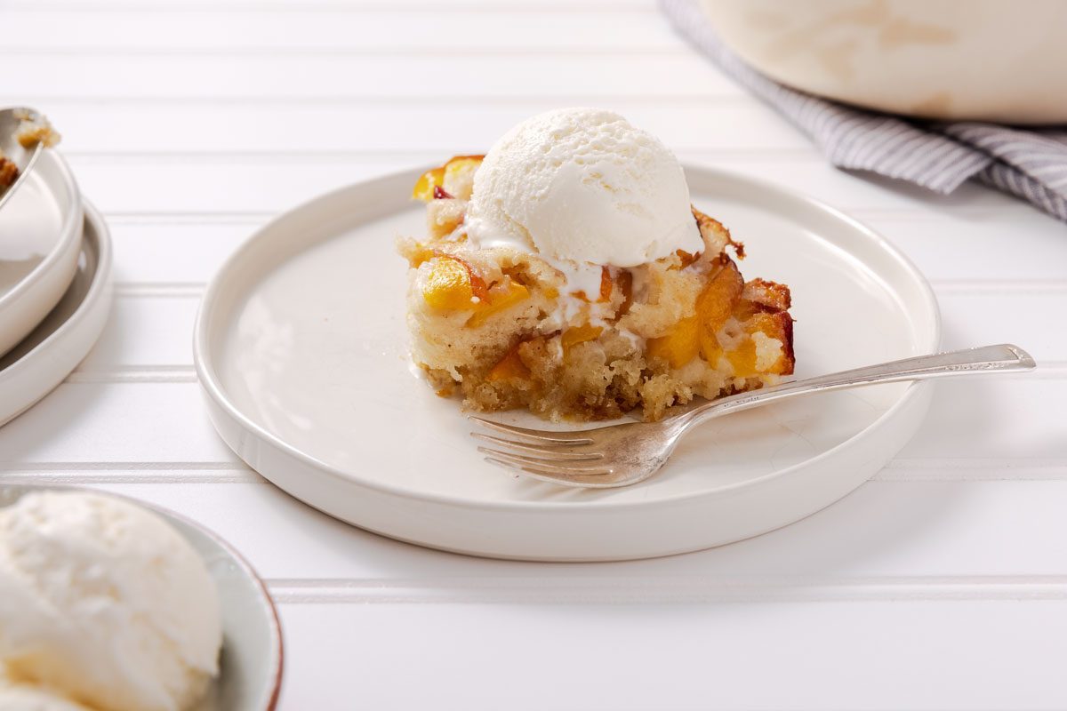 Nectarine Cobbler on a plate served with ice cream on top