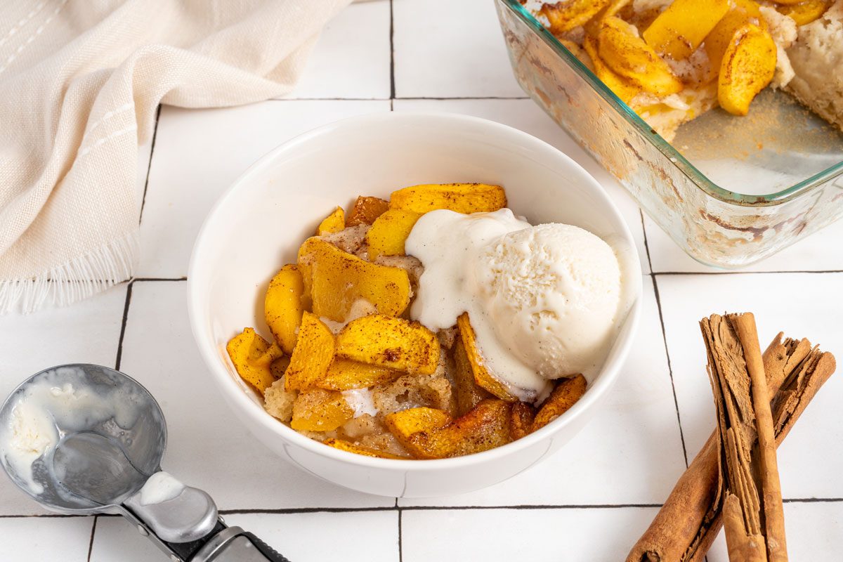  Vegan Peach Cobbler in a bowl served with ice cream