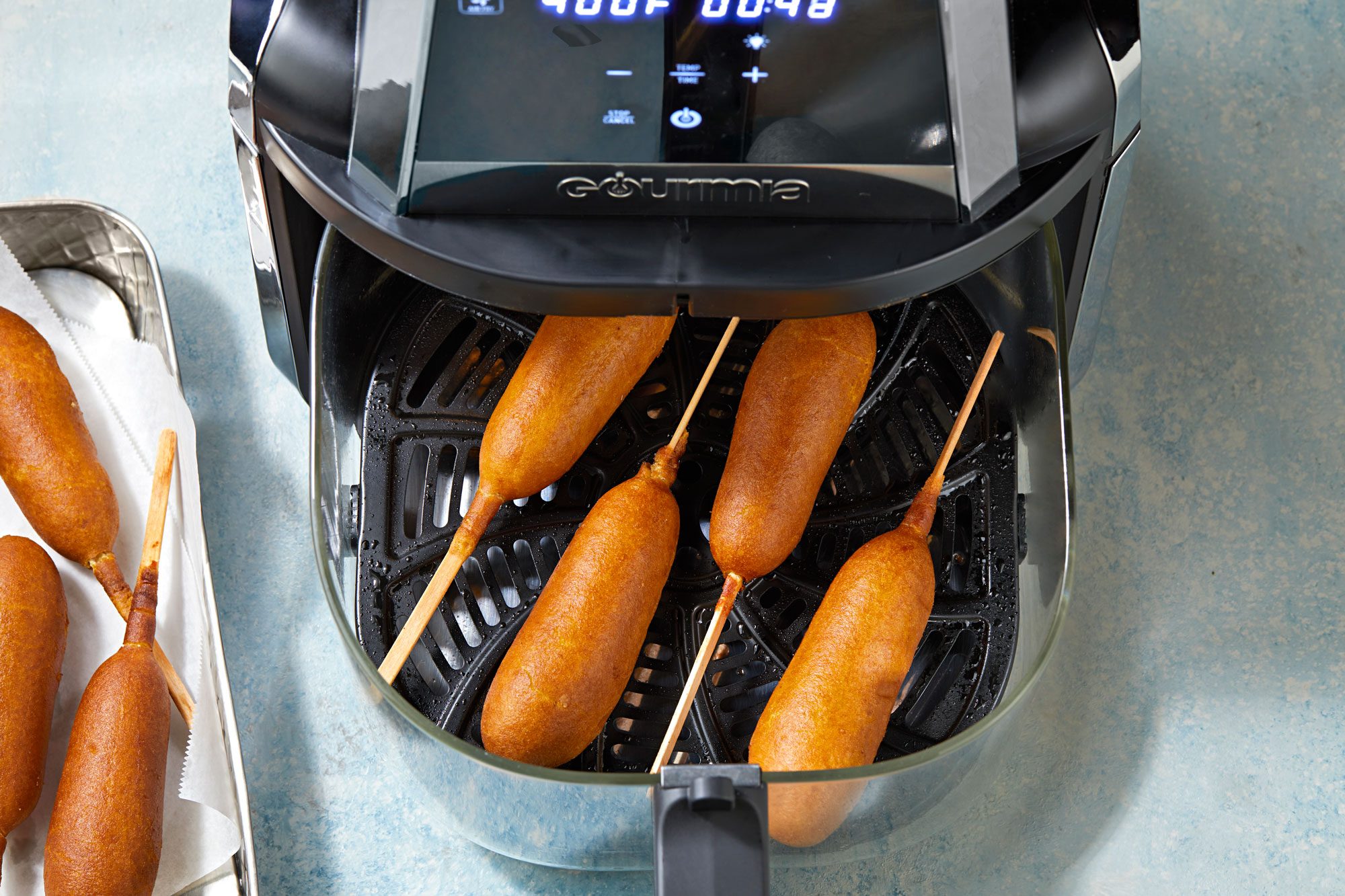 Place corn dogs on greased tray in air-fryer basket