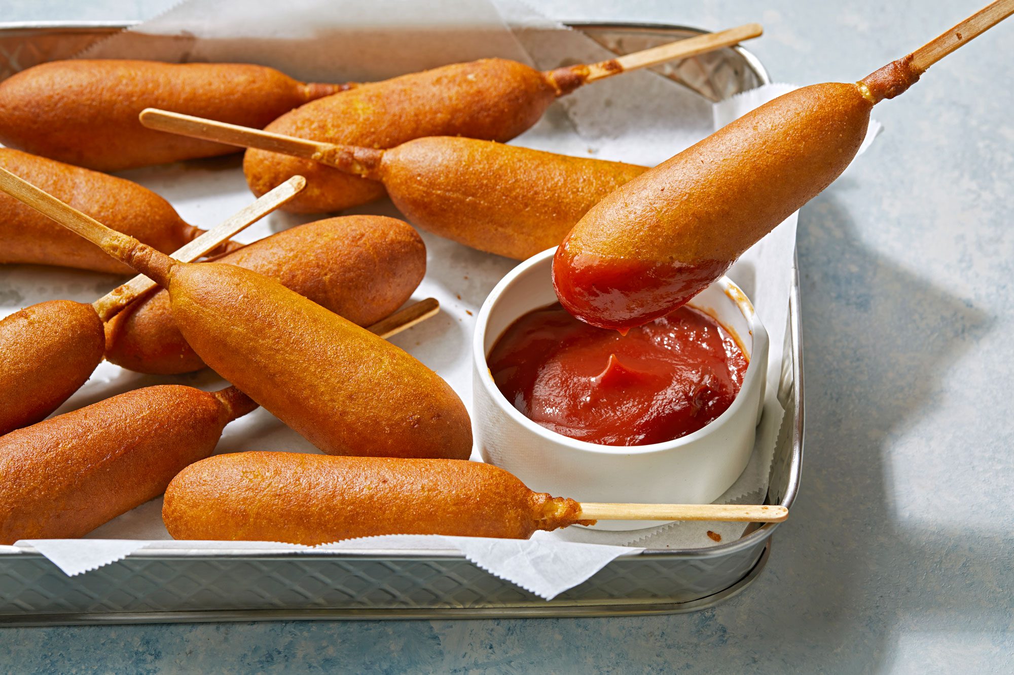 Air Fryer Corn Dogs dipped in ketchup