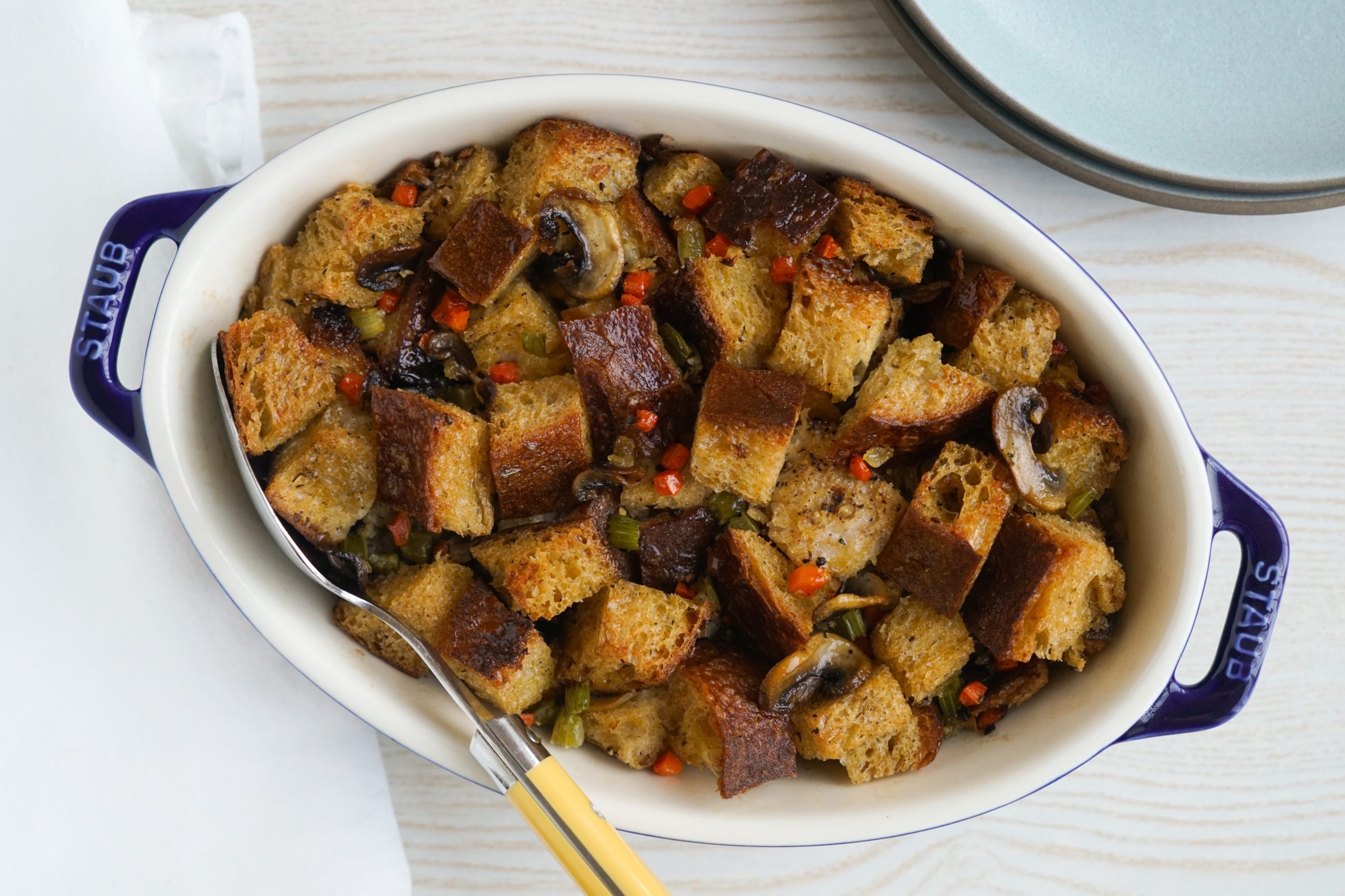 Sourdough stuffing in a blue casserole dish