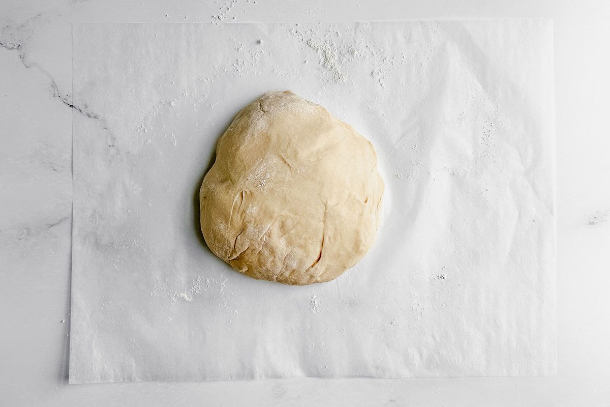 Dough on parchment paper for Taste of Home apple cinnamon rolls.