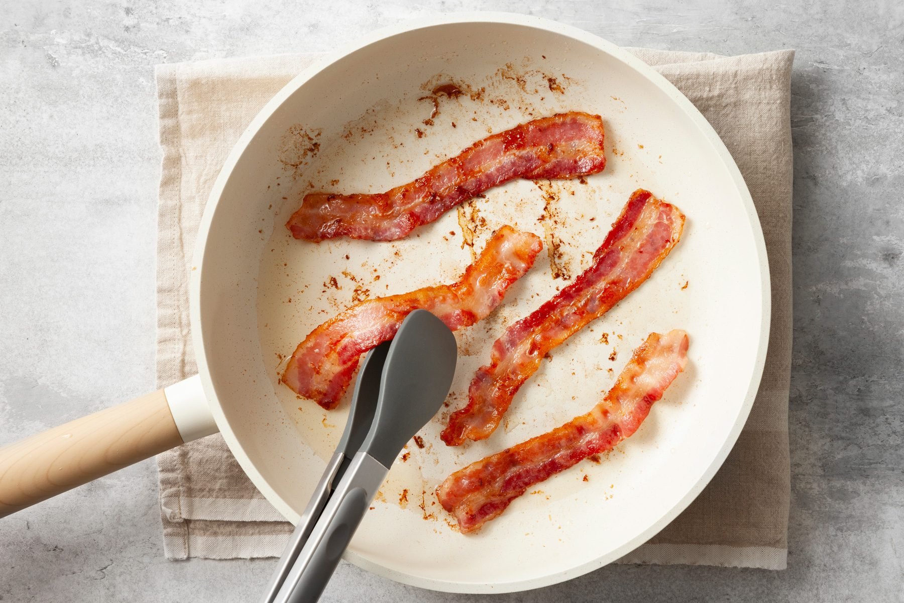 Cook bacon in a skillet top shot