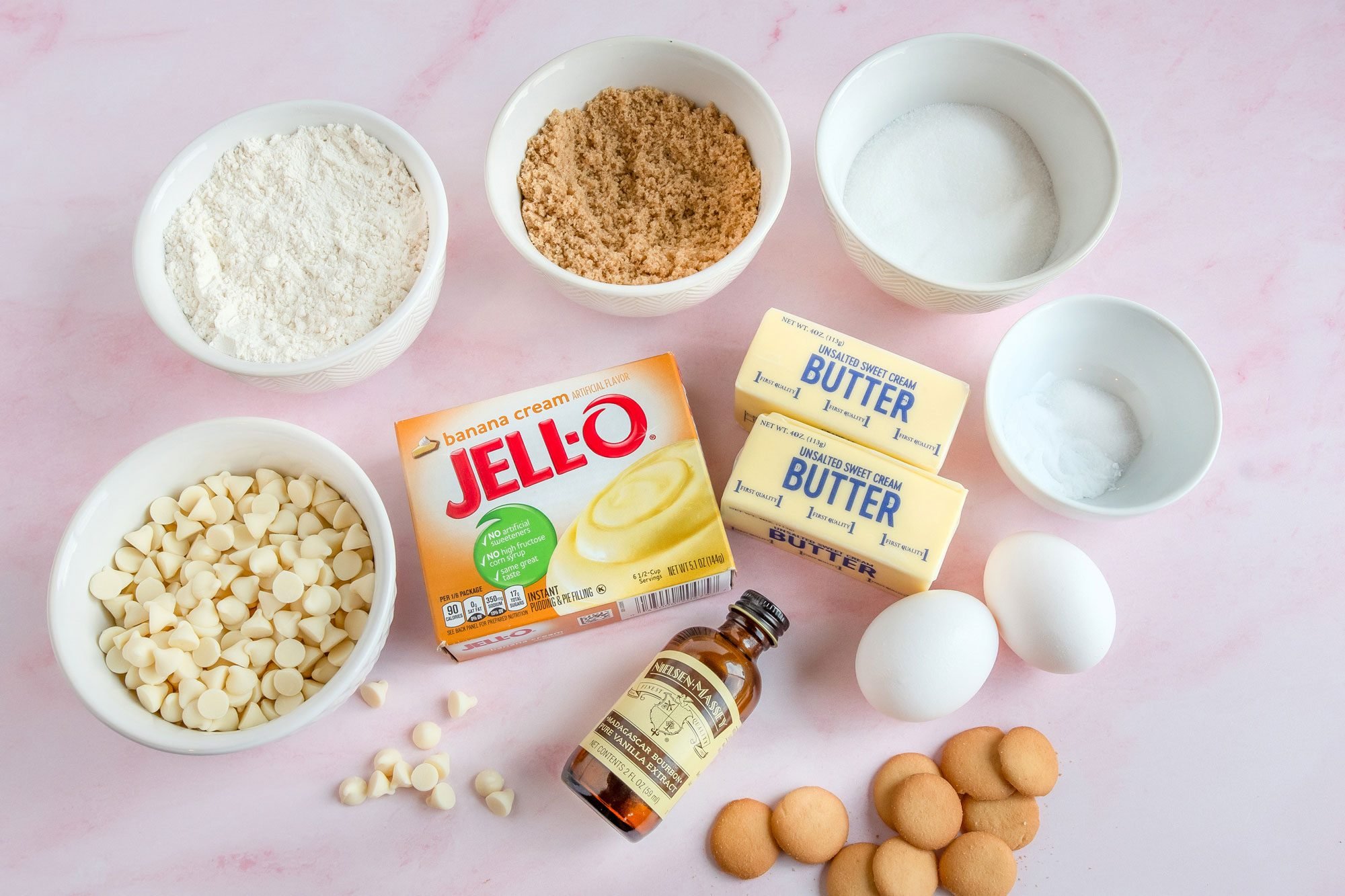 Overhead shot of all ingredients for Banana Pudding Cookies; pink texture surface;