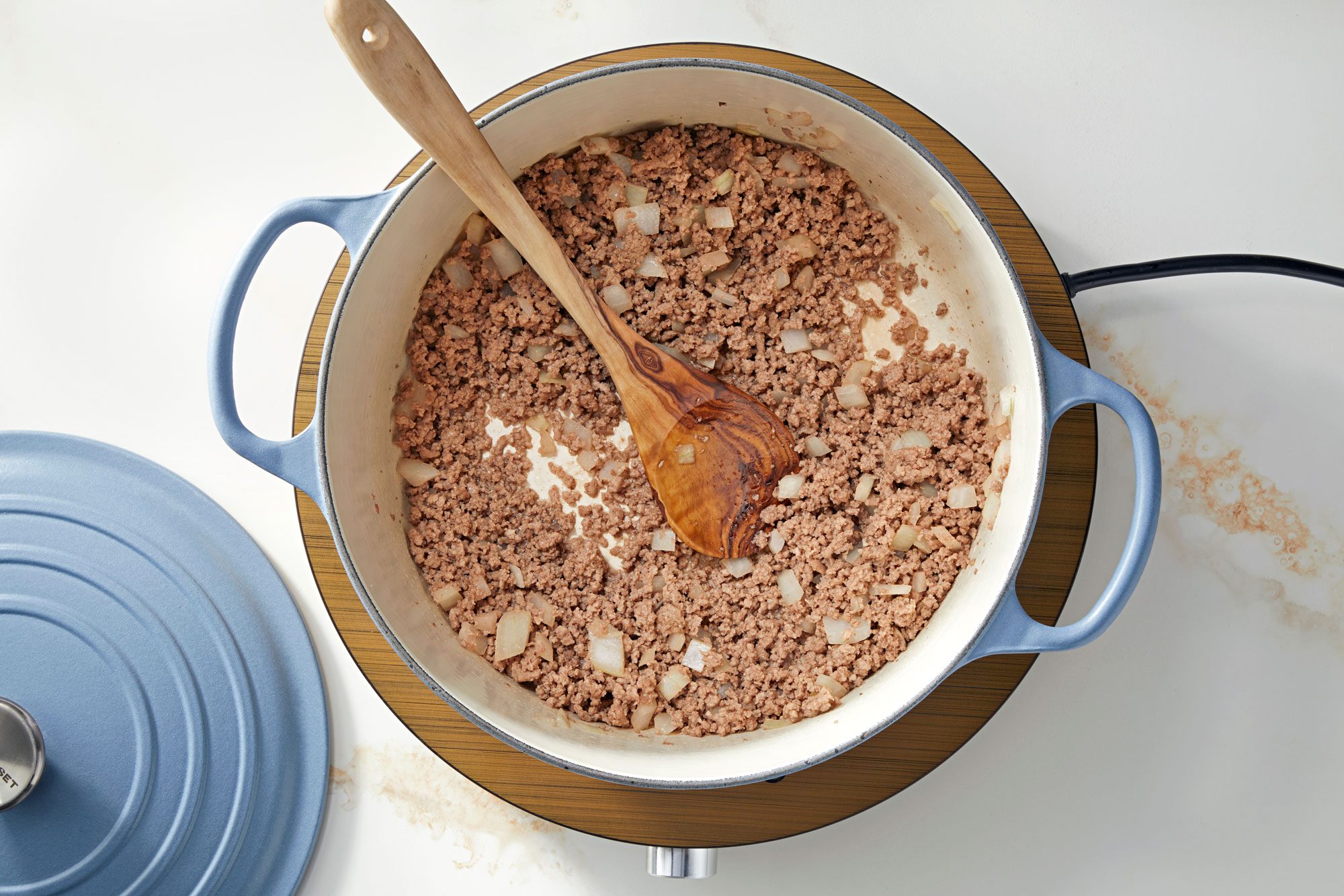 Cook the ground beef and chopped onion over medium heat in dutch oven