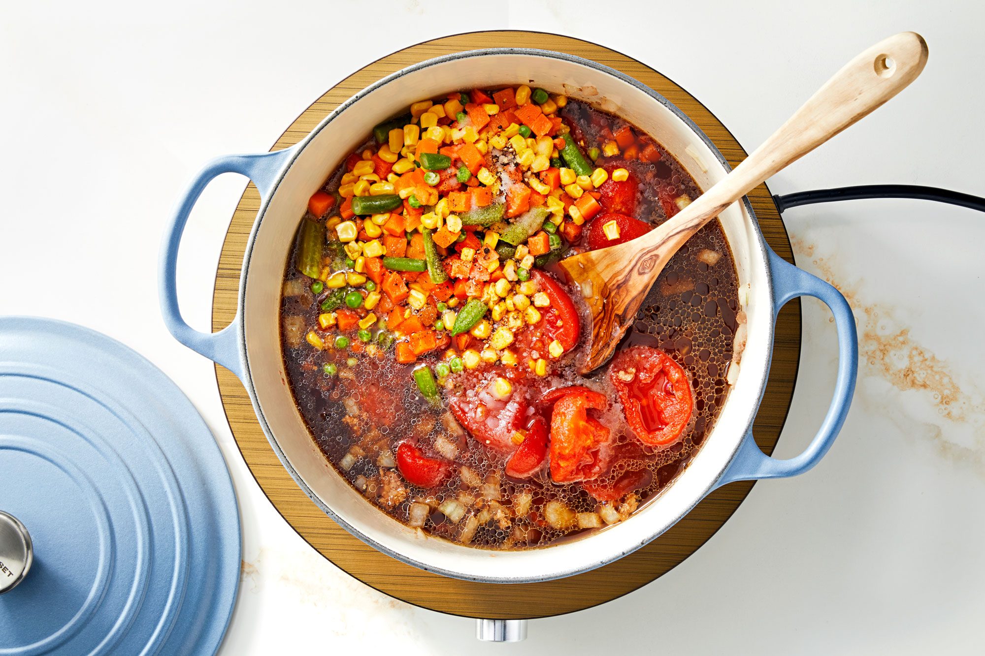 Add the stewed tomatoes, beef broth, frozen mixed veggies, salt and pepper