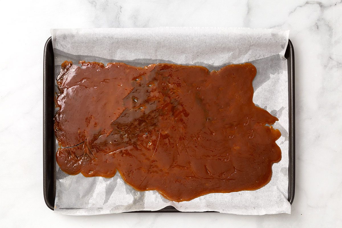 Melted butter and brown sugar in baking pan for step 1 for Butter Brickle Ice Cream for Taste of Home