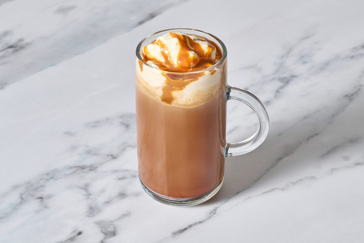 Closeup shot of one glass mug of caramel mocha topped with cream and caramel sauce