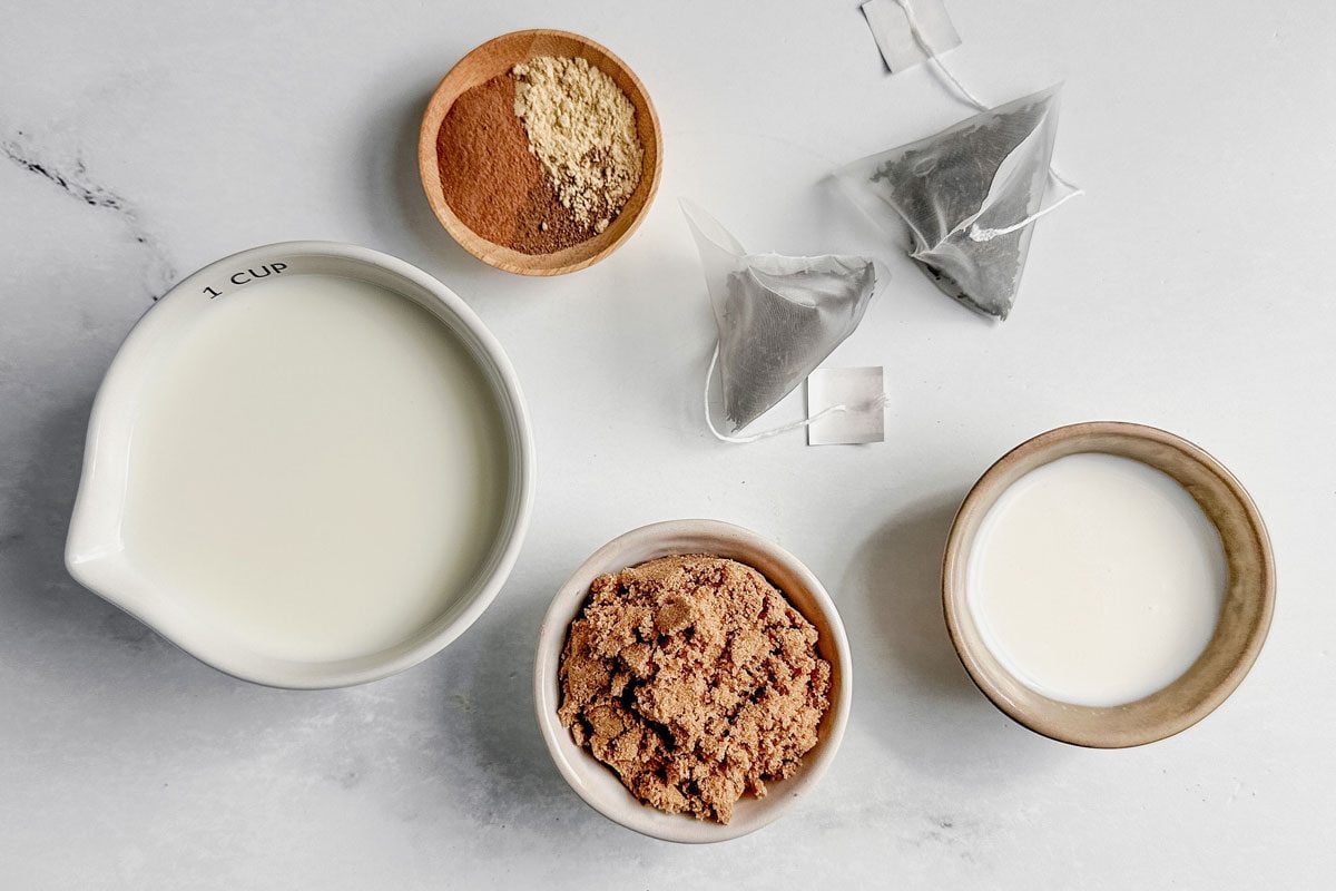 Ingredients For Taste Of Home Chai Tea Latte On A Marble Surface.