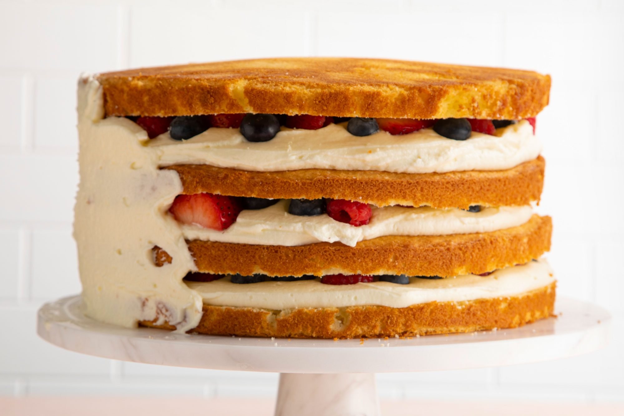 Chantilly cake on a marble cake stand.