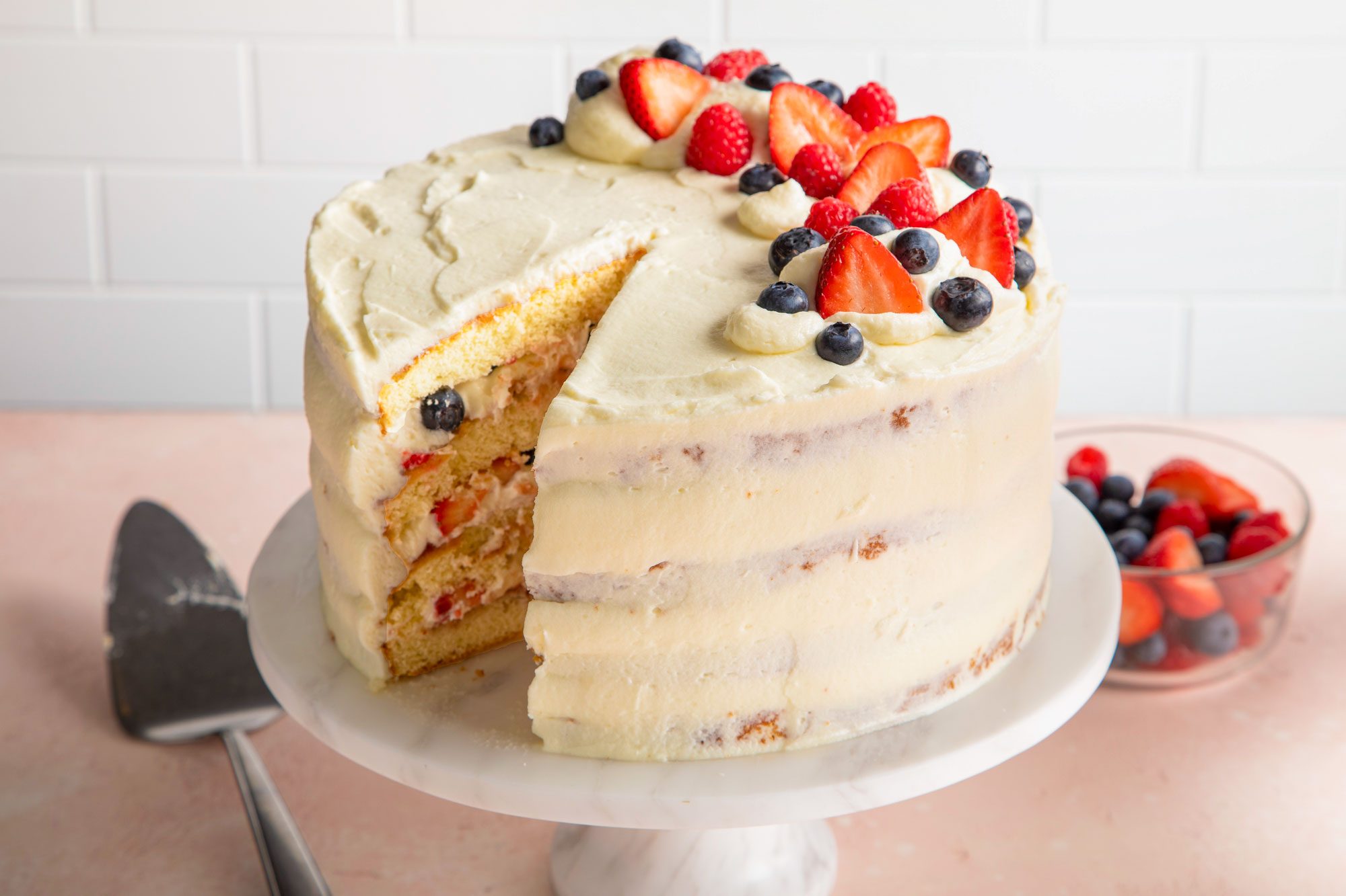 Chantilly cake on a marble cake stand.