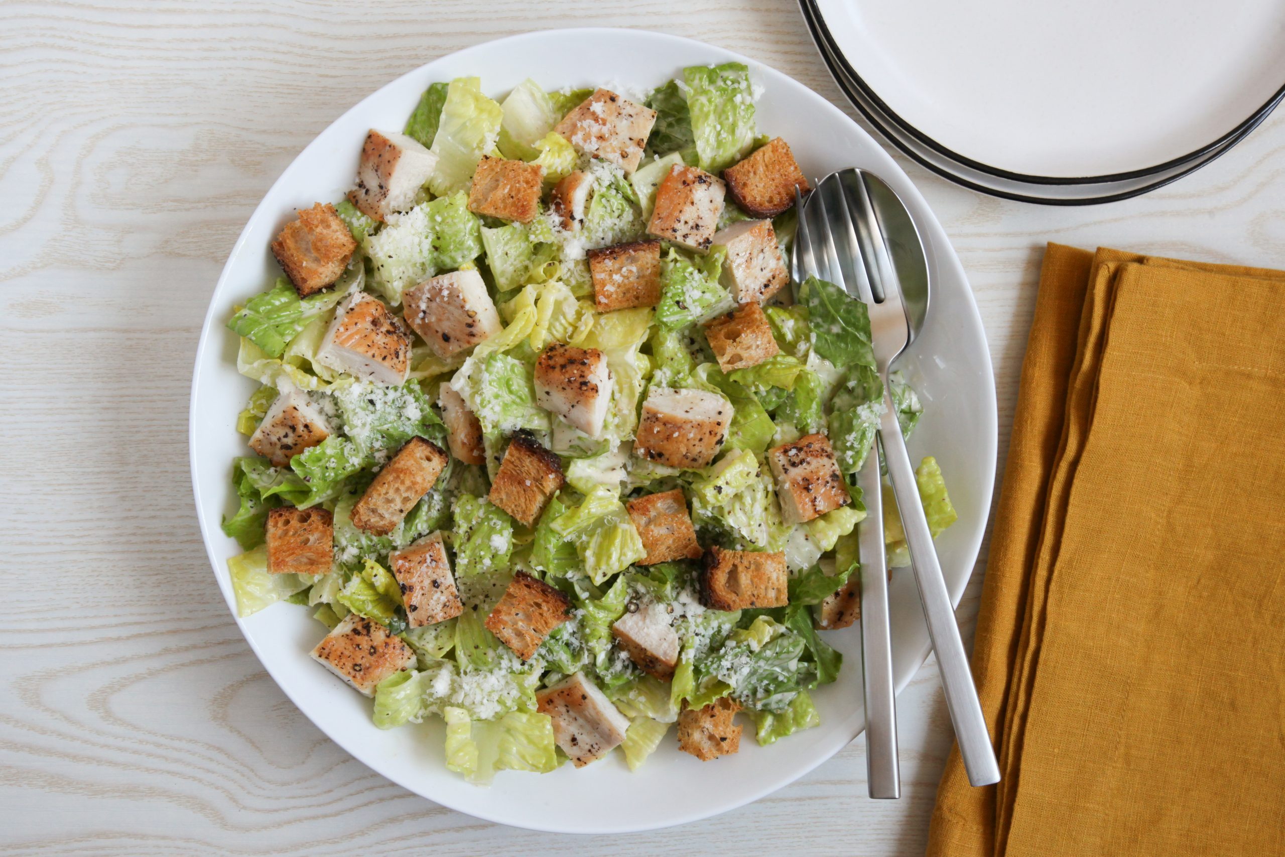 A large bowl of chicken caesar salad