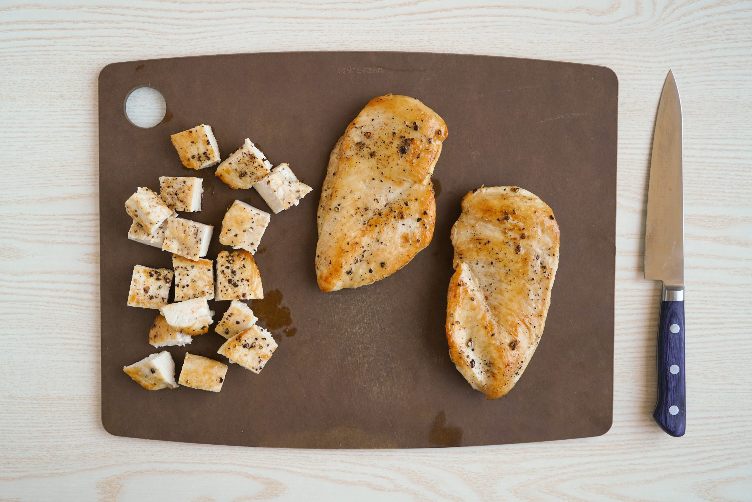 Cutting chicken breasts for chicken caesar salad