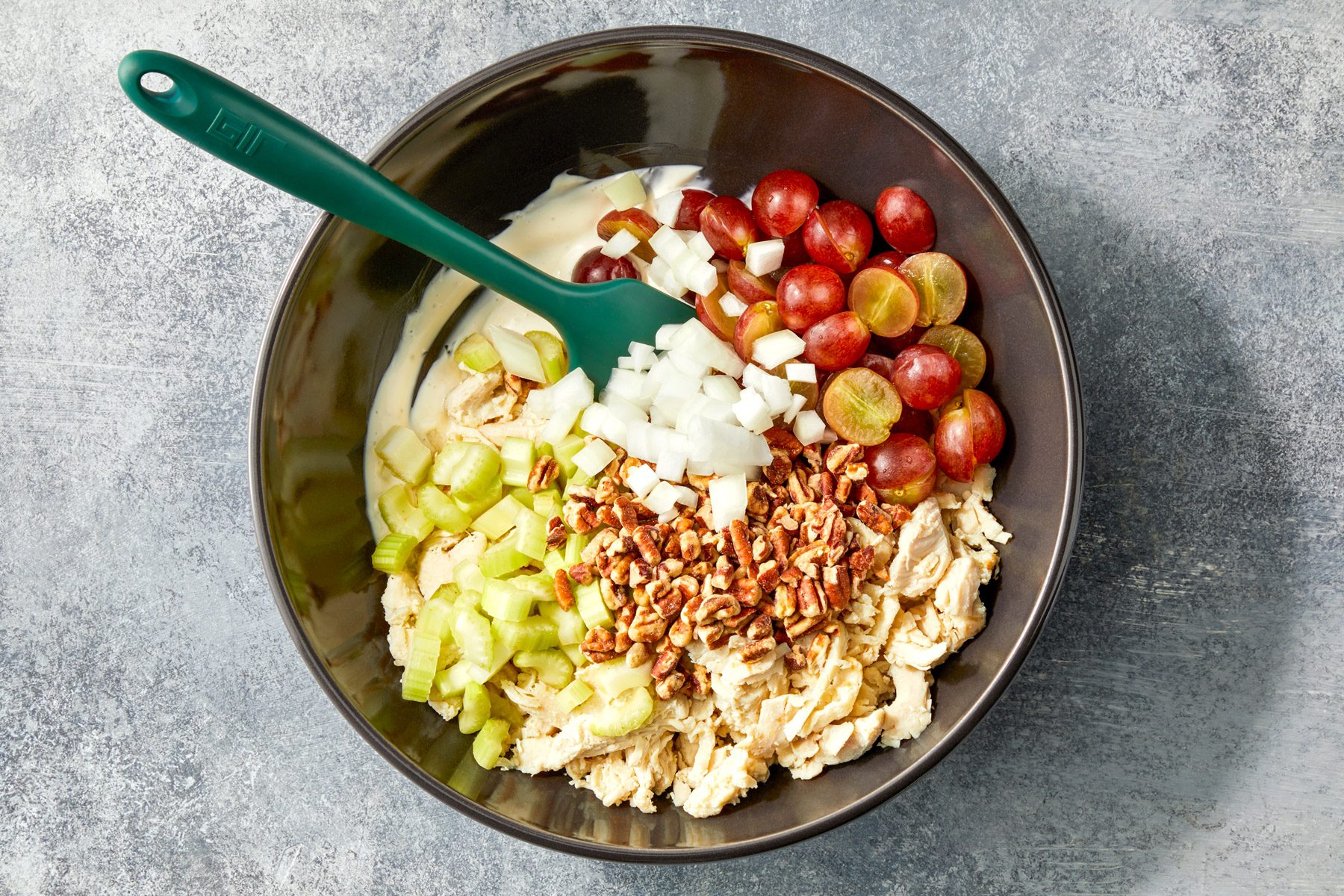 Chicken, grapes, pecans, celery and onions in a large bowl.