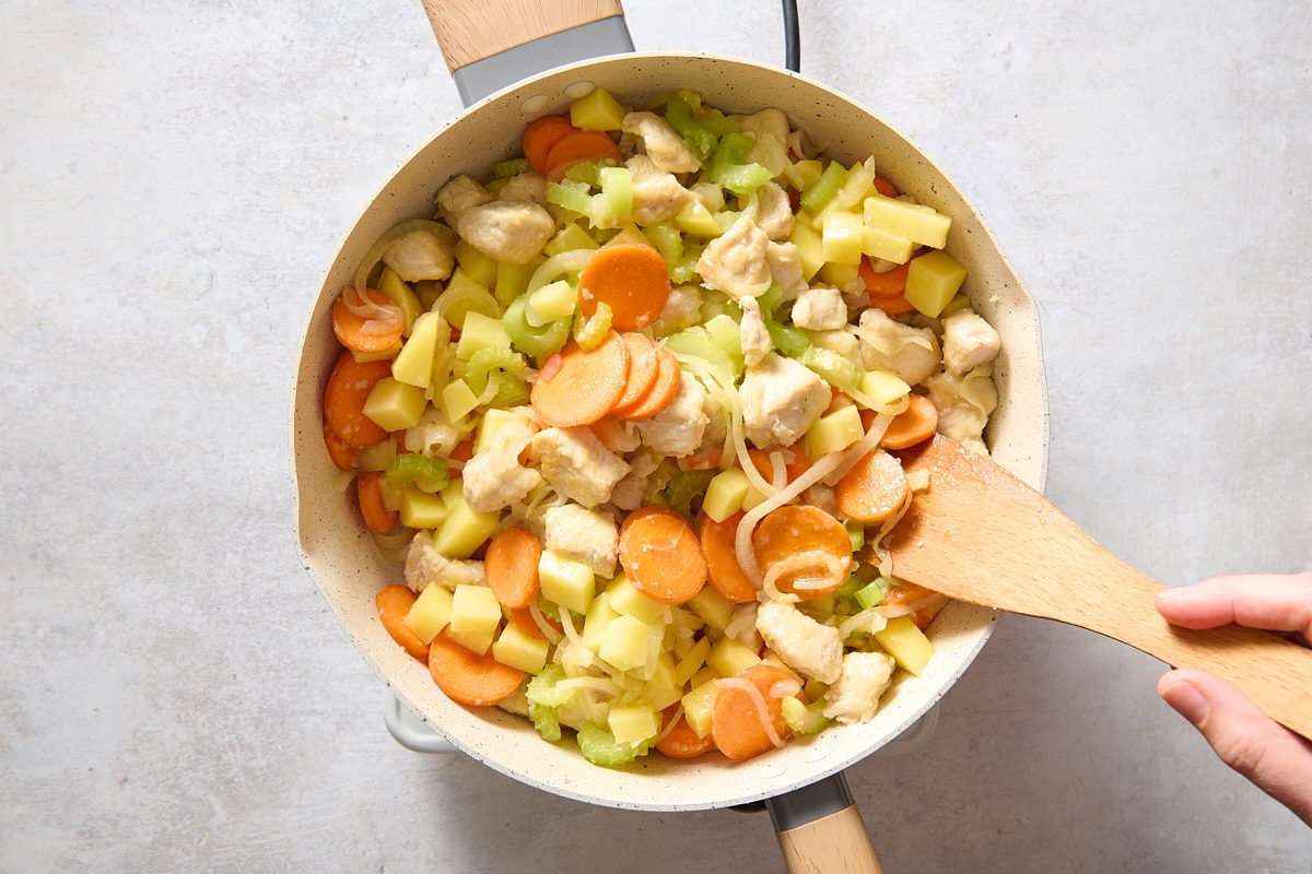 Cooking the chicken and vegetables in a large skillet