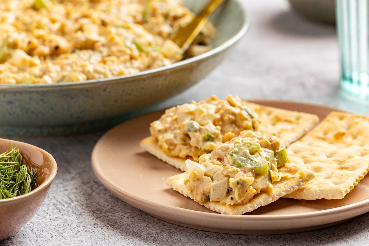 Taste of Home Chickpea Tuna Salad recipe photo of the finished recipe in a bowl with a side of saltine crackers.