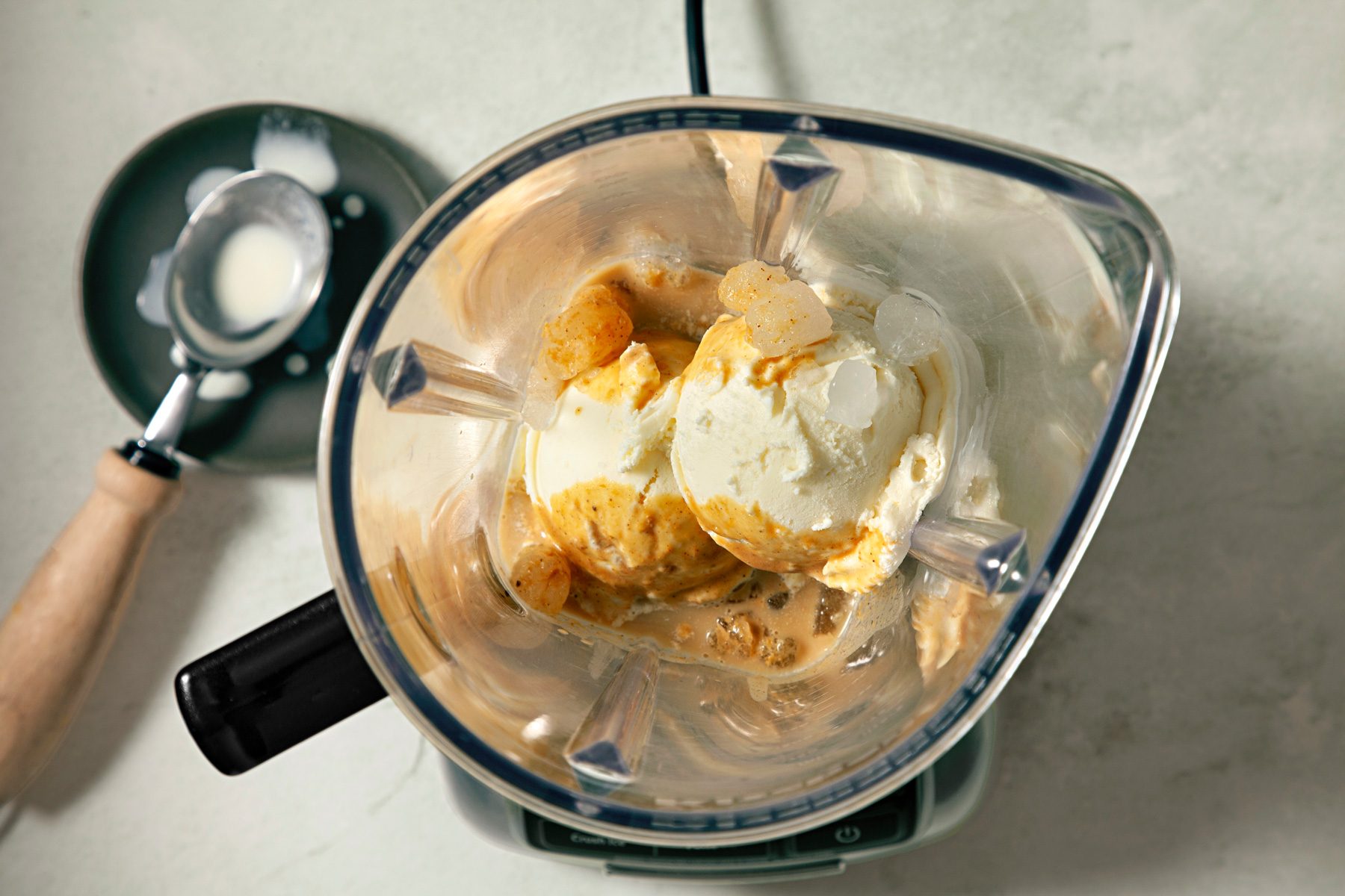 Top view shot of pumpkin mixture and ice cream in a blender