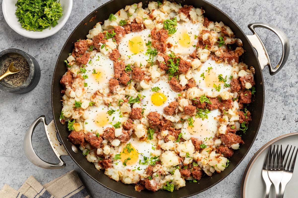 Taste of Home Corned Beef Hash and Eggs recipe photo of the finished recipe in a skillet. 