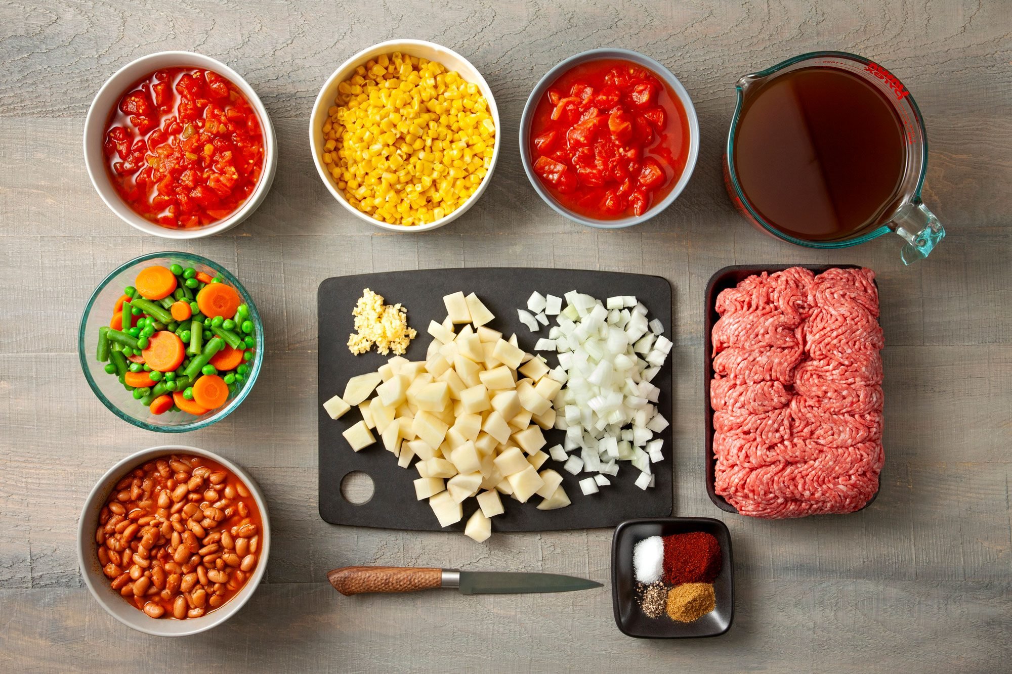 overhead shot of ingredients for Cowboy Soup; wooden background;