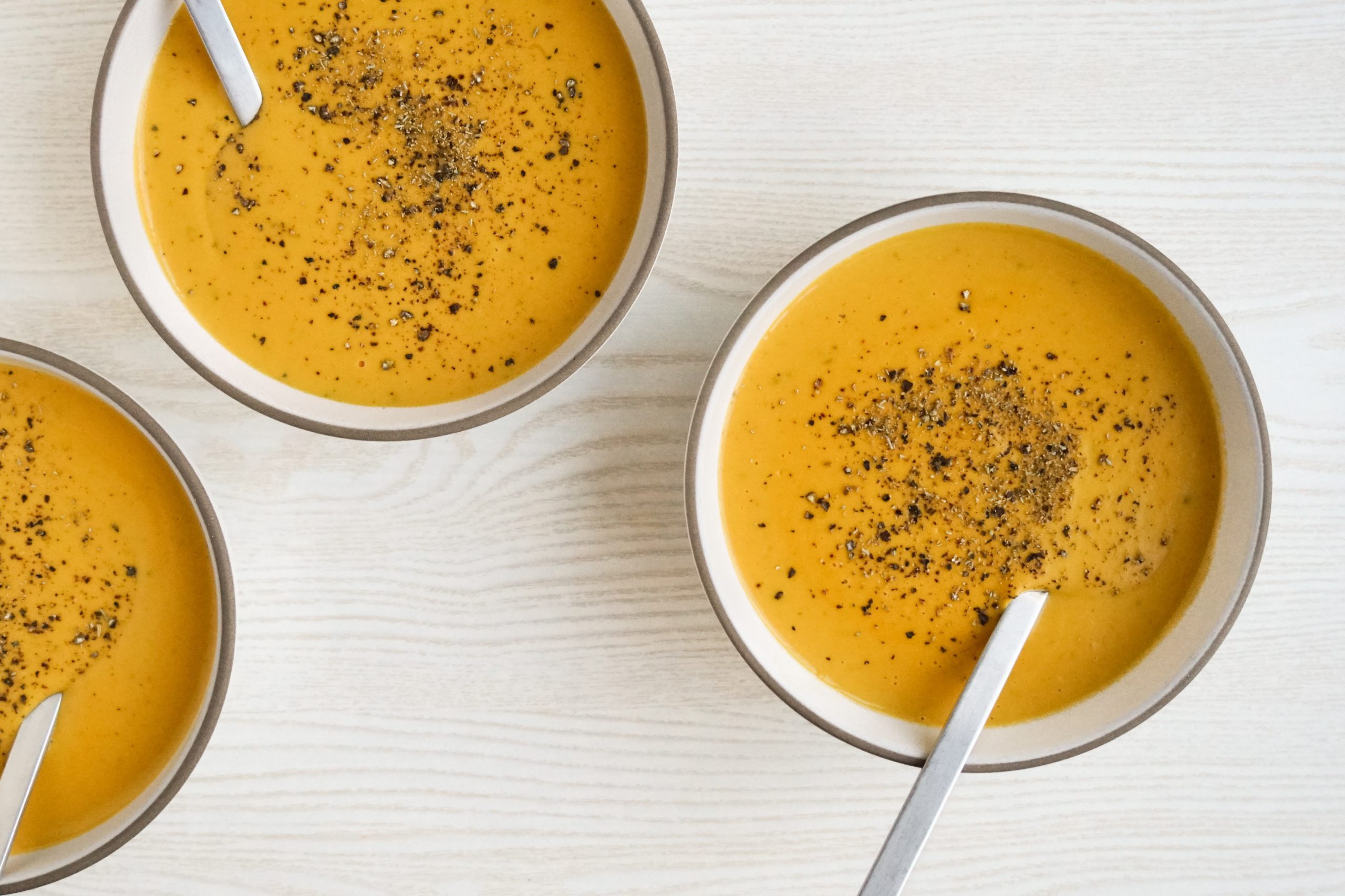 Creamy carrot soup in bowls