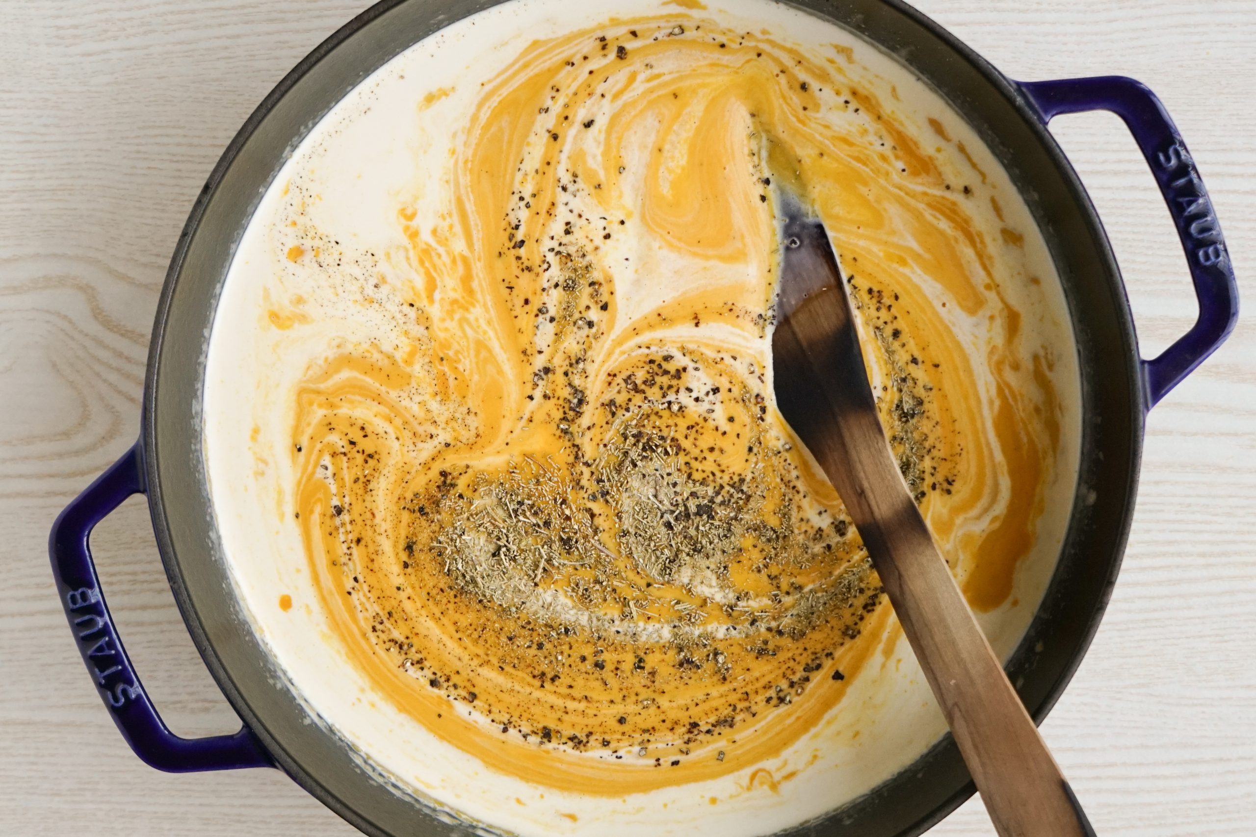 Adding cream to creamy carrot soup