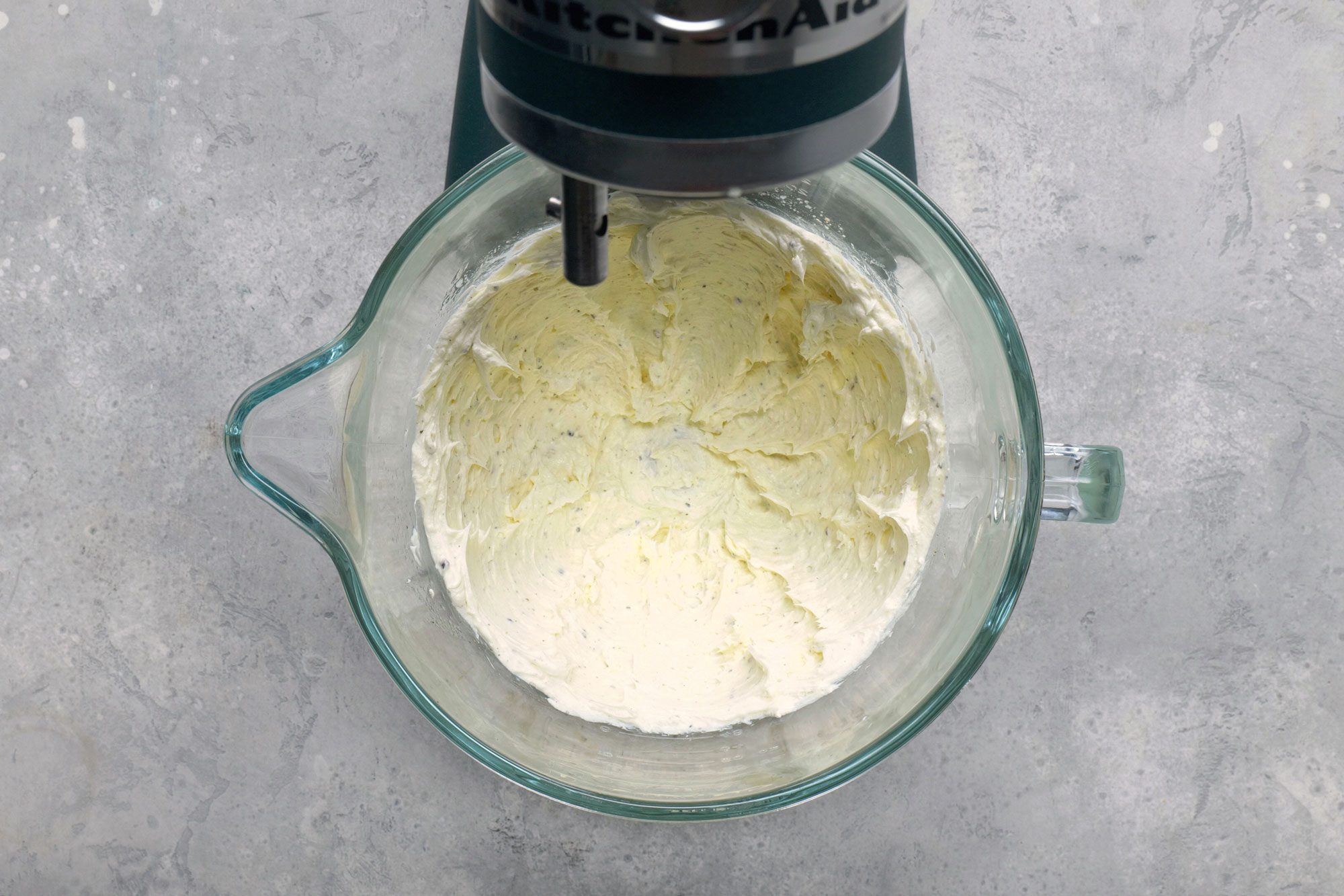 In a mixer, beat cream cheese, 1/2 cup melted butter, salt and pepper until smooth