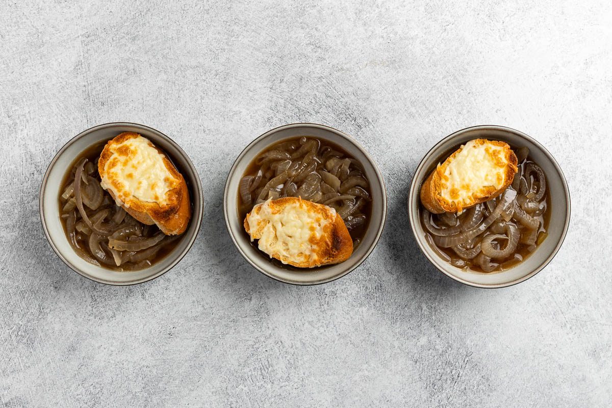 Taste of Home Crock Pot French Onion Soup recipe photo of the cheese melted on top of the baguettes placed on the soups.