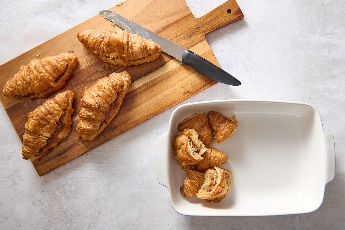 Placing prepared croissants into a baking dish