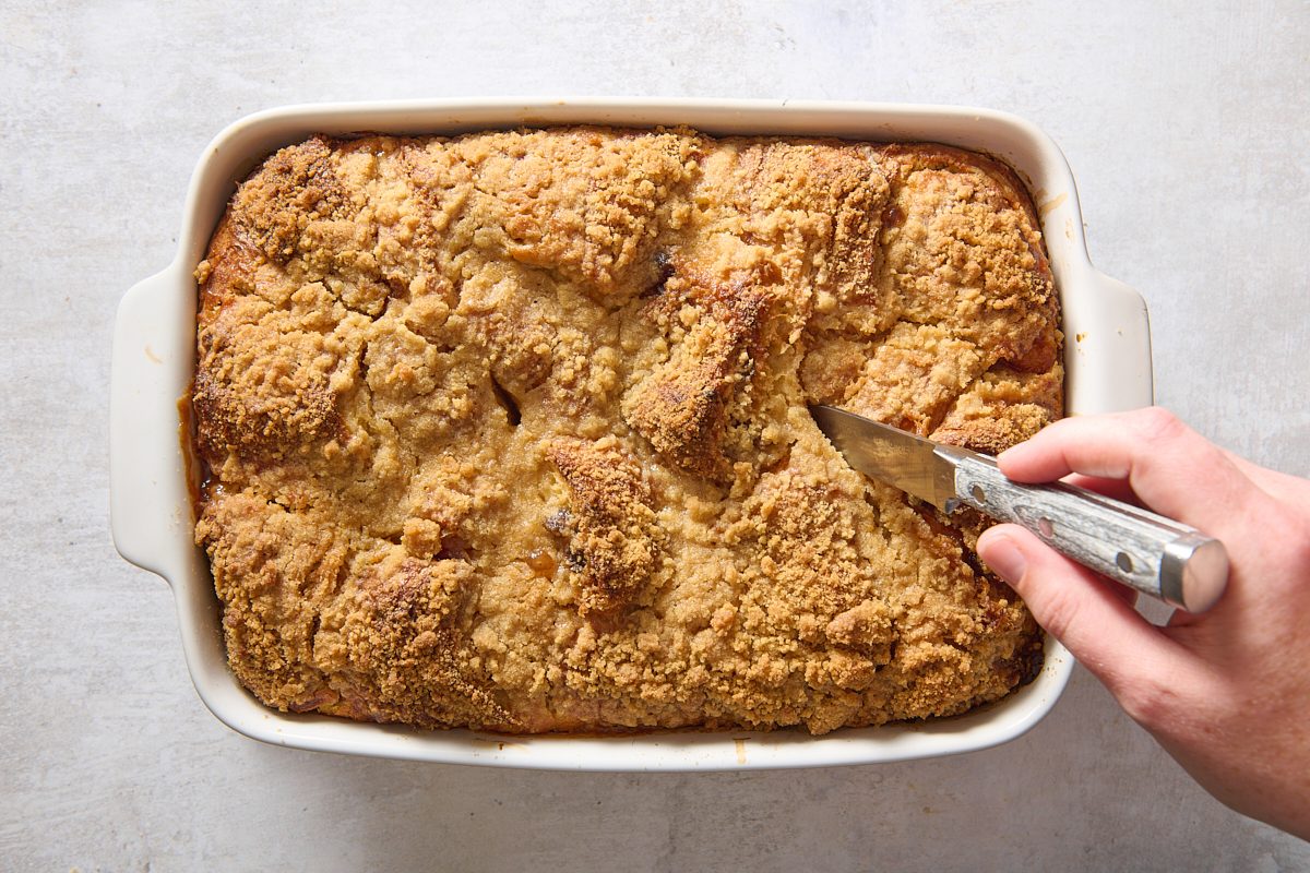 Testing the cooked croissant pudding with a knife