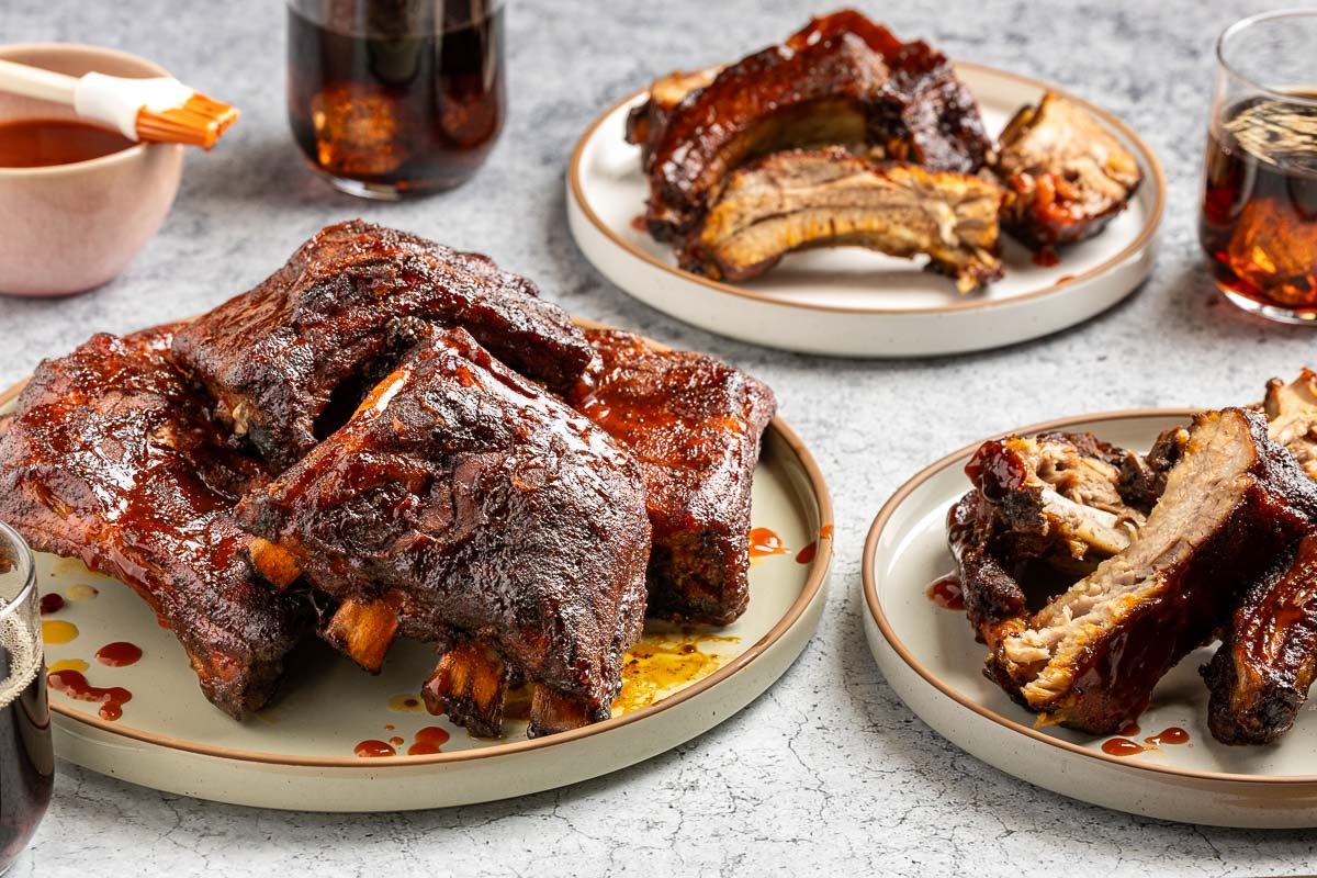 Taste of Home Dr Pepper ribs recipe photo of the final recipe served on a platter and plates.