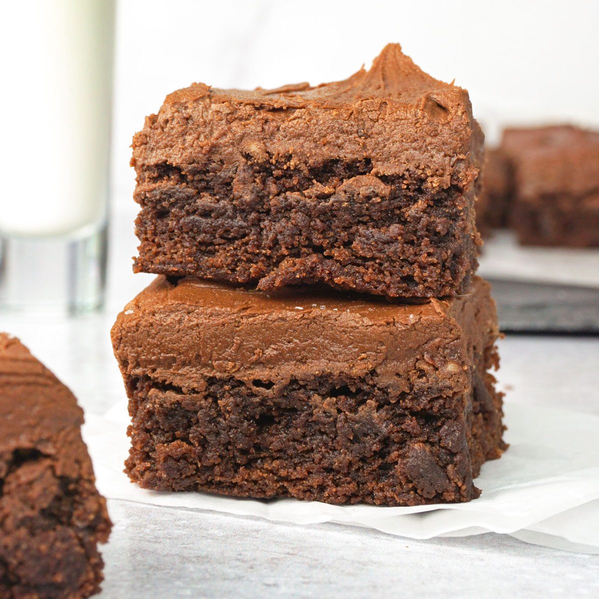 two Frosted Brownies stacked, view from the side close up