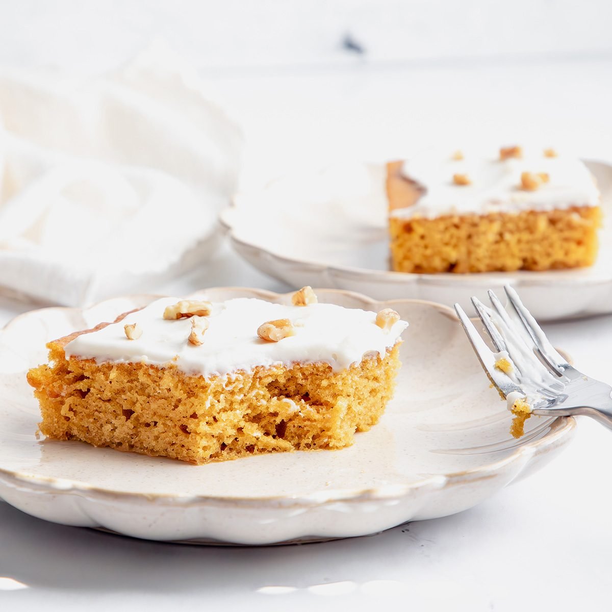 Close Up Beauty Shot For Taste Of Home Pumpkin Sheet Cake On A Marble Surface.