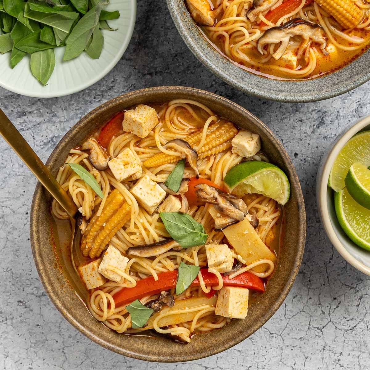 Taste of Home Thai Curry Soup recipe photo of the finished recipe served into bowls garnised with fresh basil and lime.