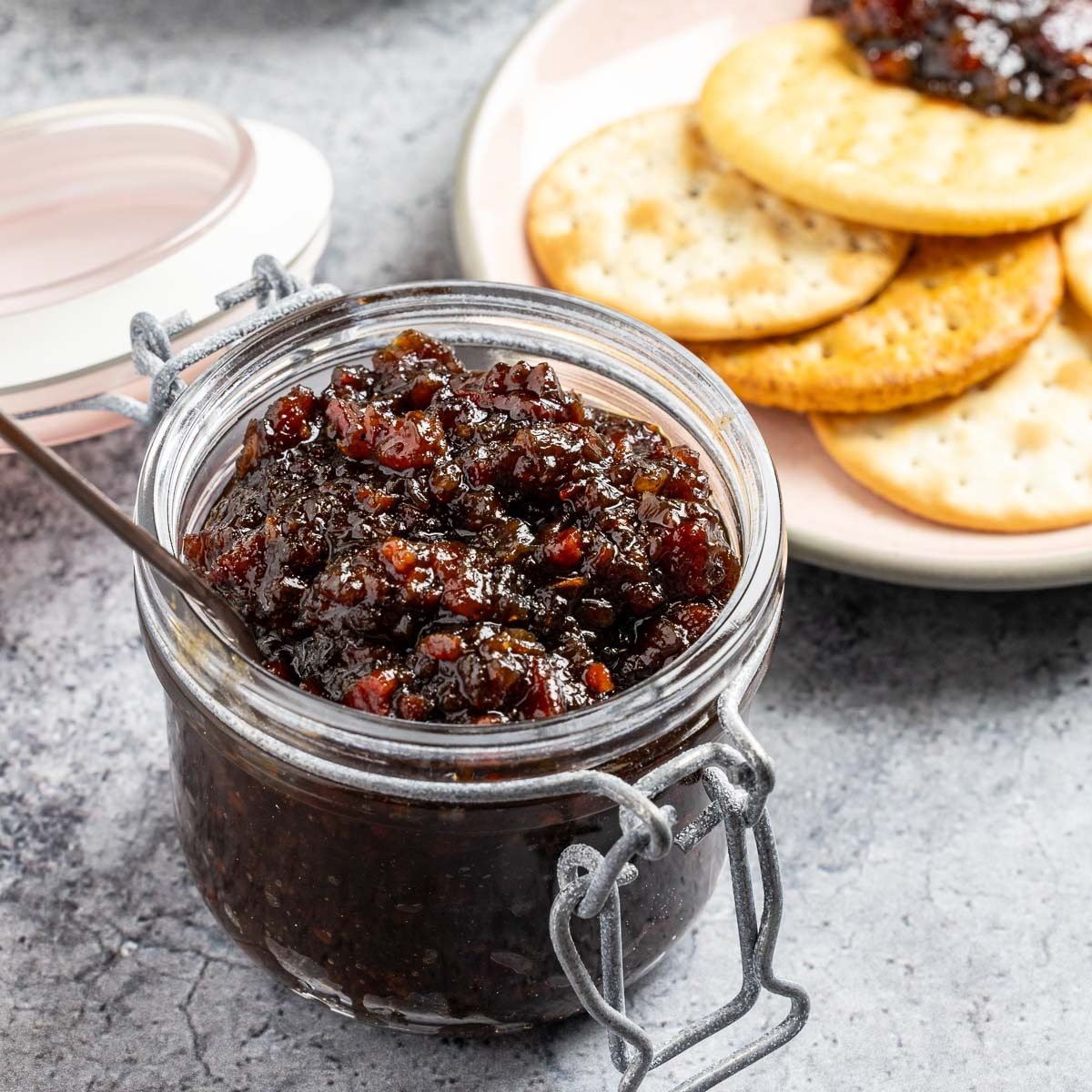 Taste of Home Bourbon Bacon Jam recipe photo of the finished recipe served with crackers.