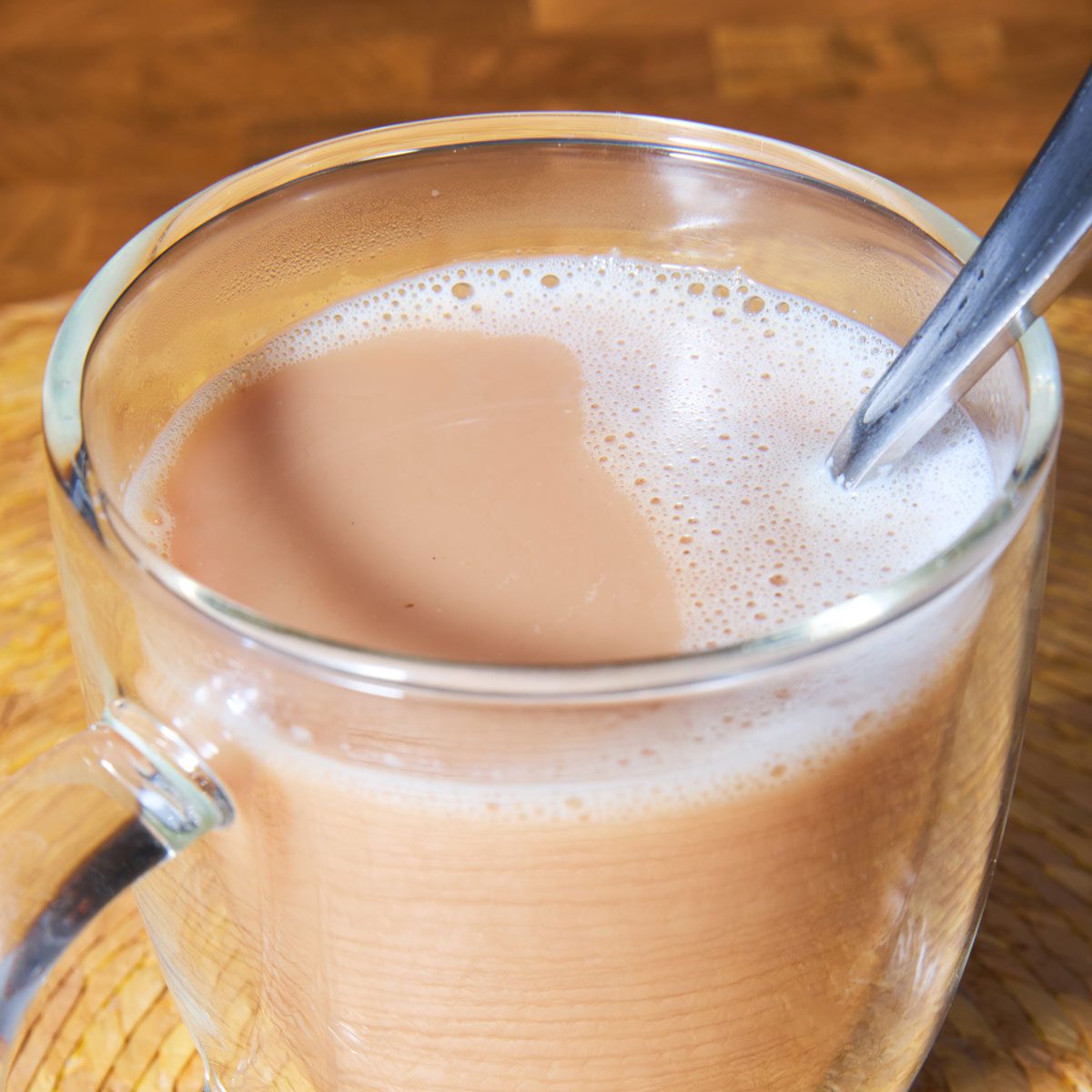 Chai in clear glass mug with spoon