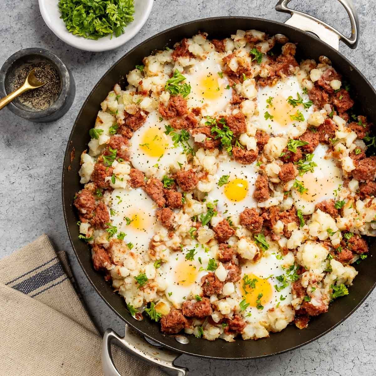 Taste of Home Corned Beef Hash and Eggs recipe photo of the finished recipe in a skillet.