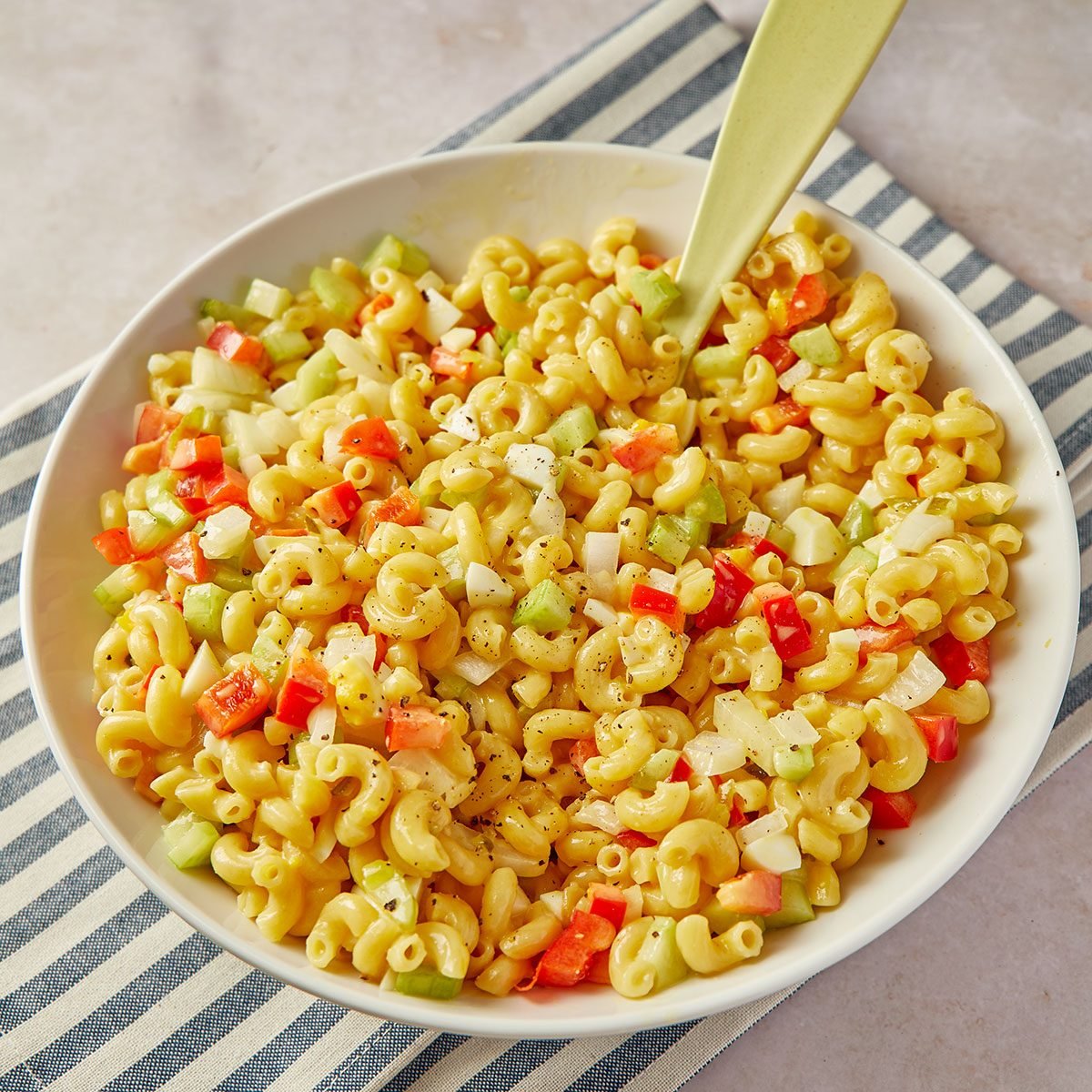 Amish macaroni salad is a perfect side dish for summer get-togethers. Make up a big bowl for your next barbecue or block party, and wait for the compliments to roll in.